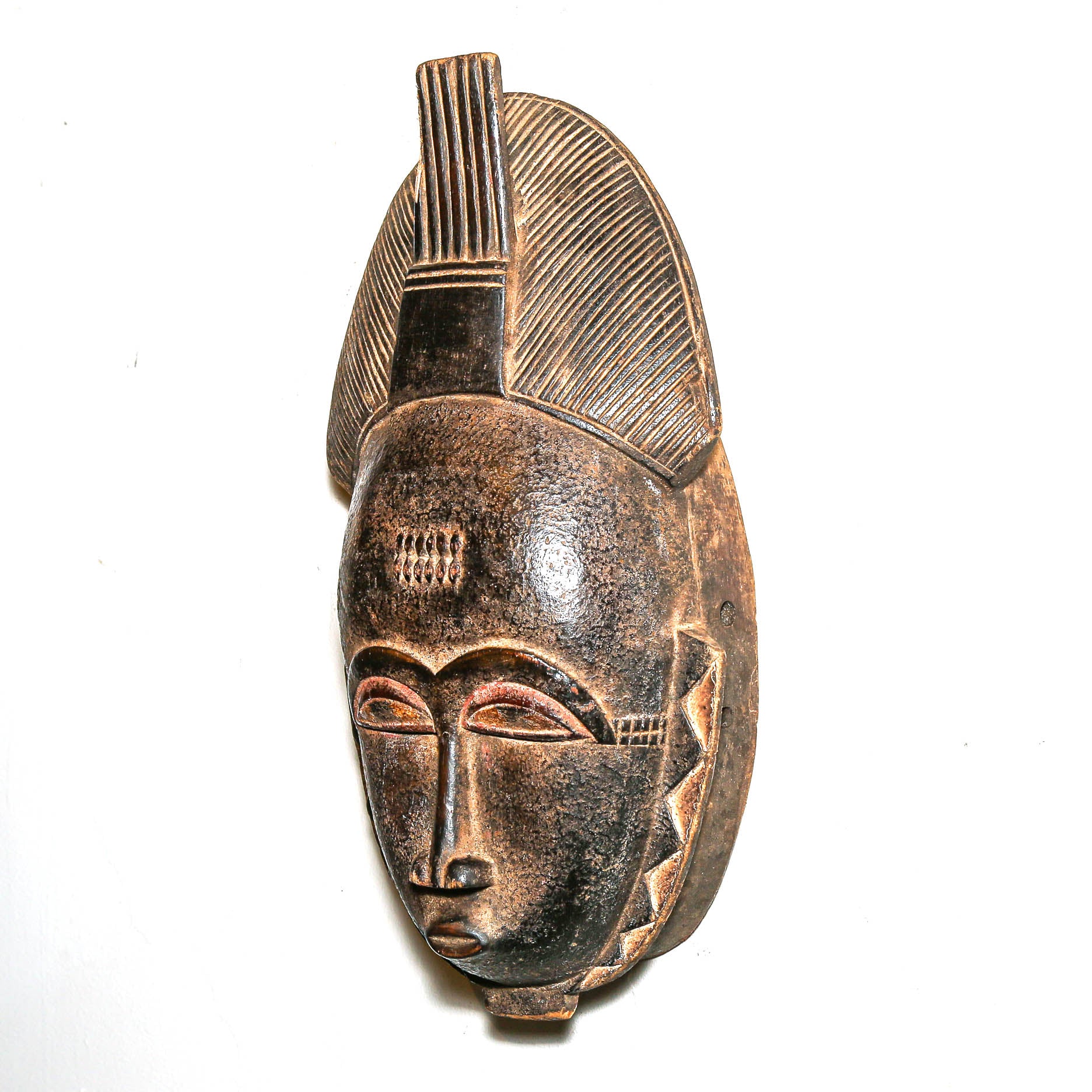 African-style wooden mask on a white background to hand on bedroom wall