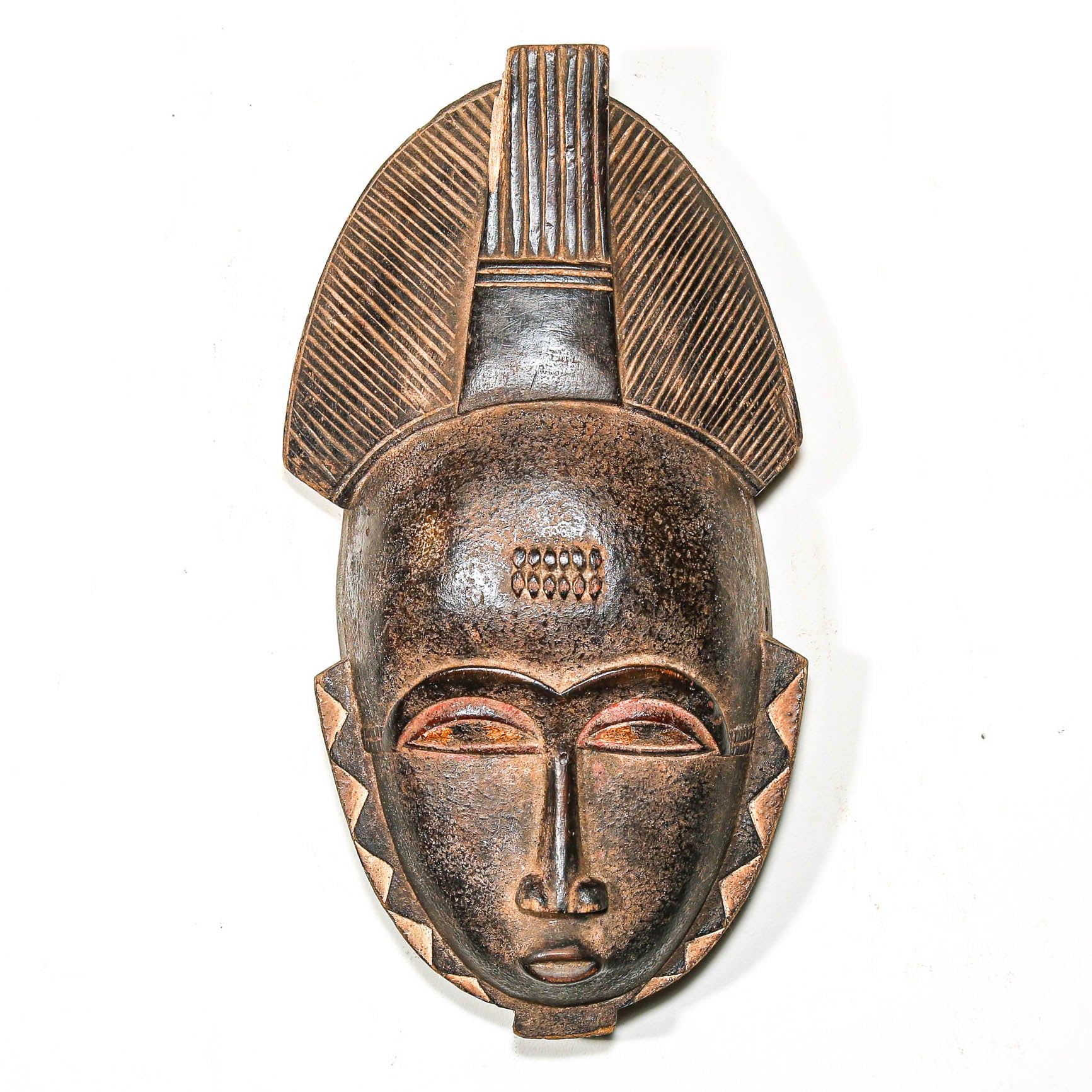 African mask with intricate design on a white background to put on living room wall