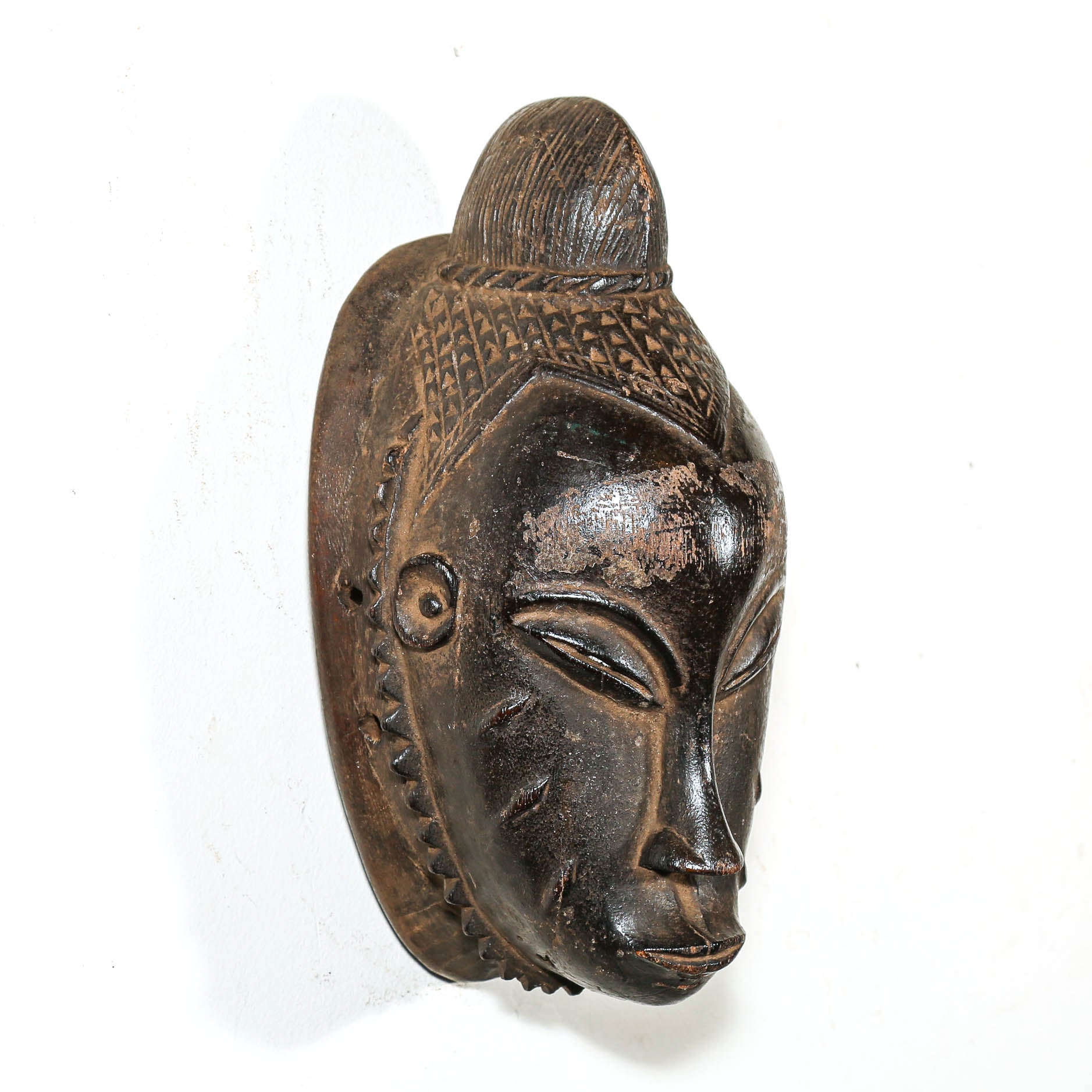 Black African Traditional wooden mask on a white background