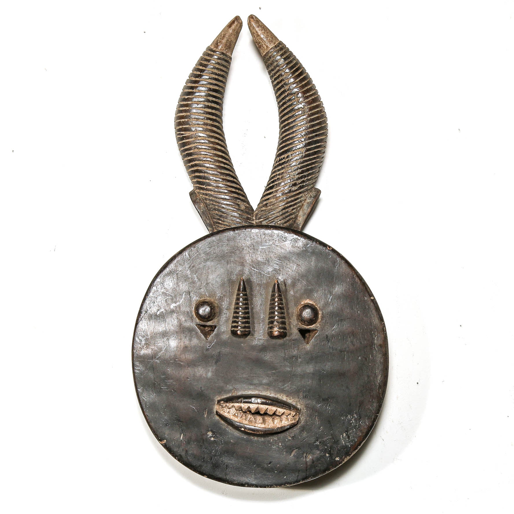 Decorative black art african mask with antelope horns on a white background