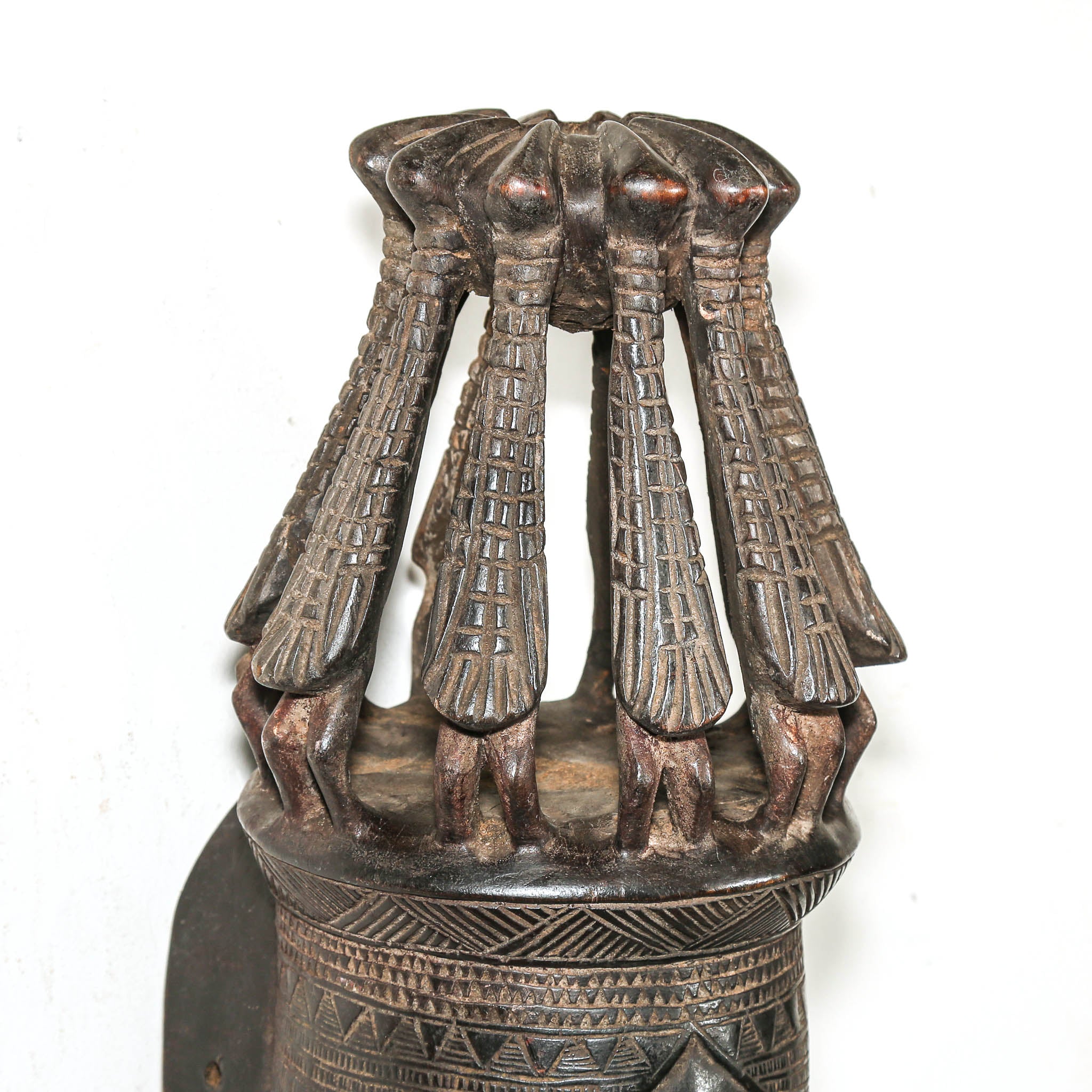 African mask with bird headdress on a white wall