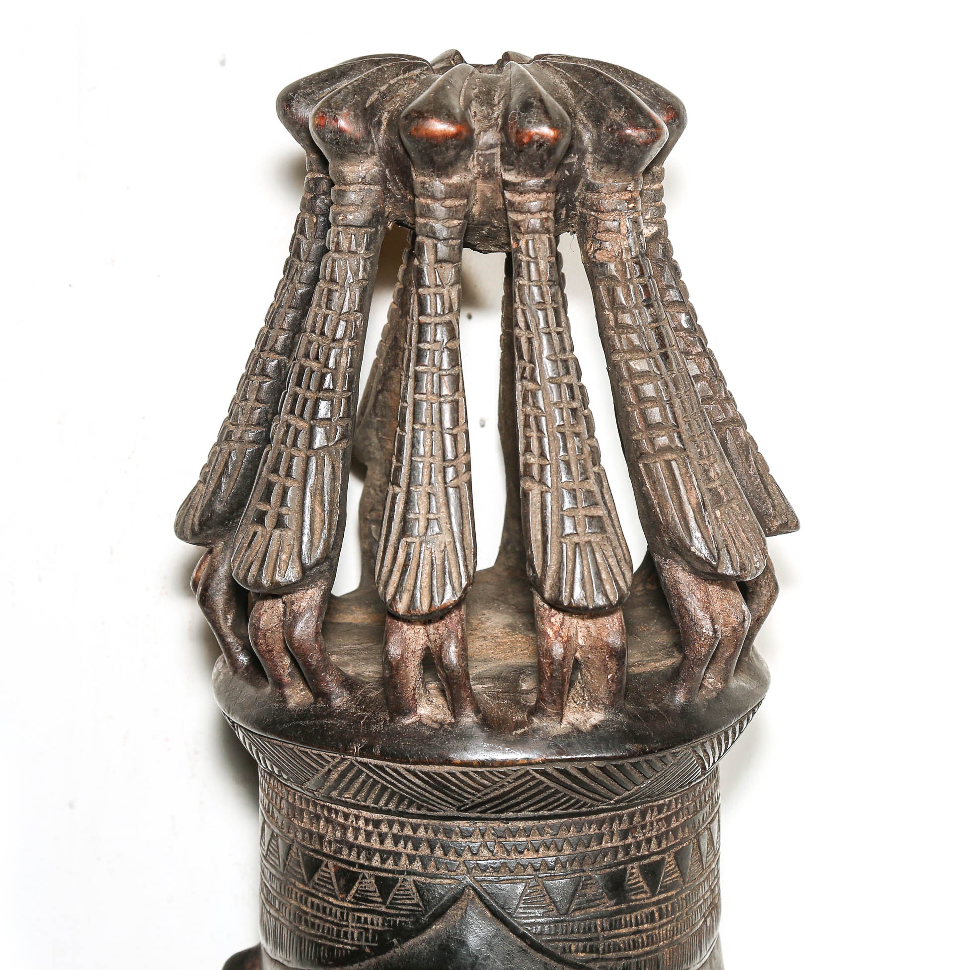 Decorative bronze sculpture with multiple hands and a detailed base on a white background
