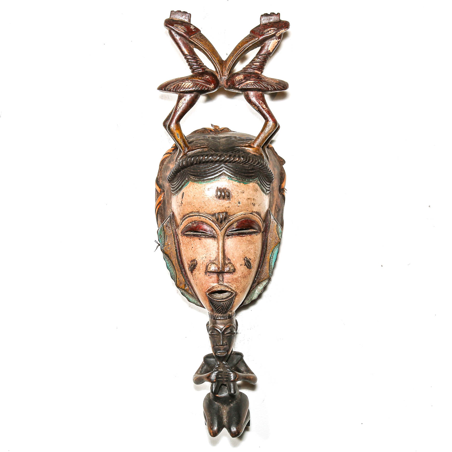 African mask with detailed carvings on a white background