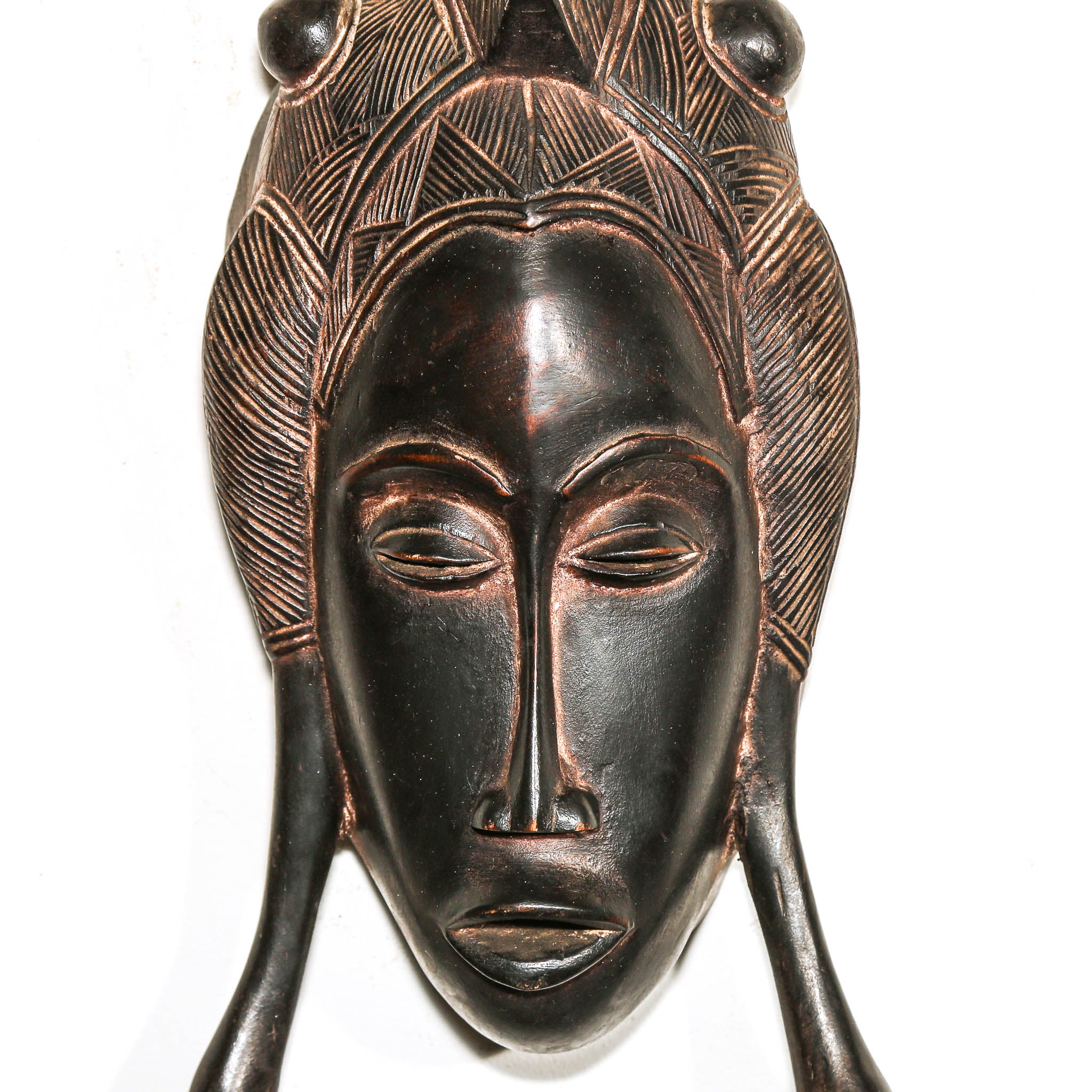 Decorative mask with intricate designs on a white background