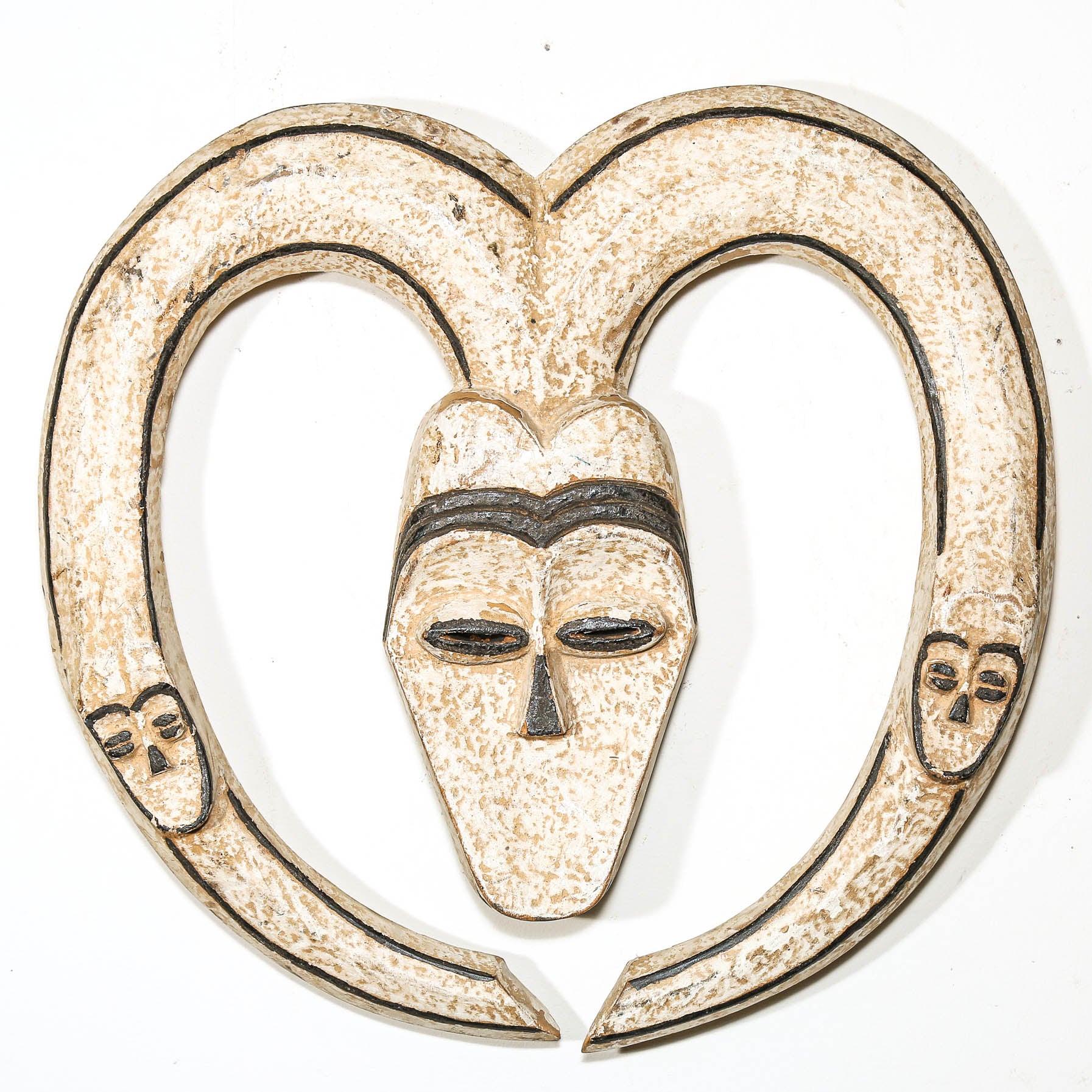 Decorative wall hanging African mask with a heart shape and black lines on a white background