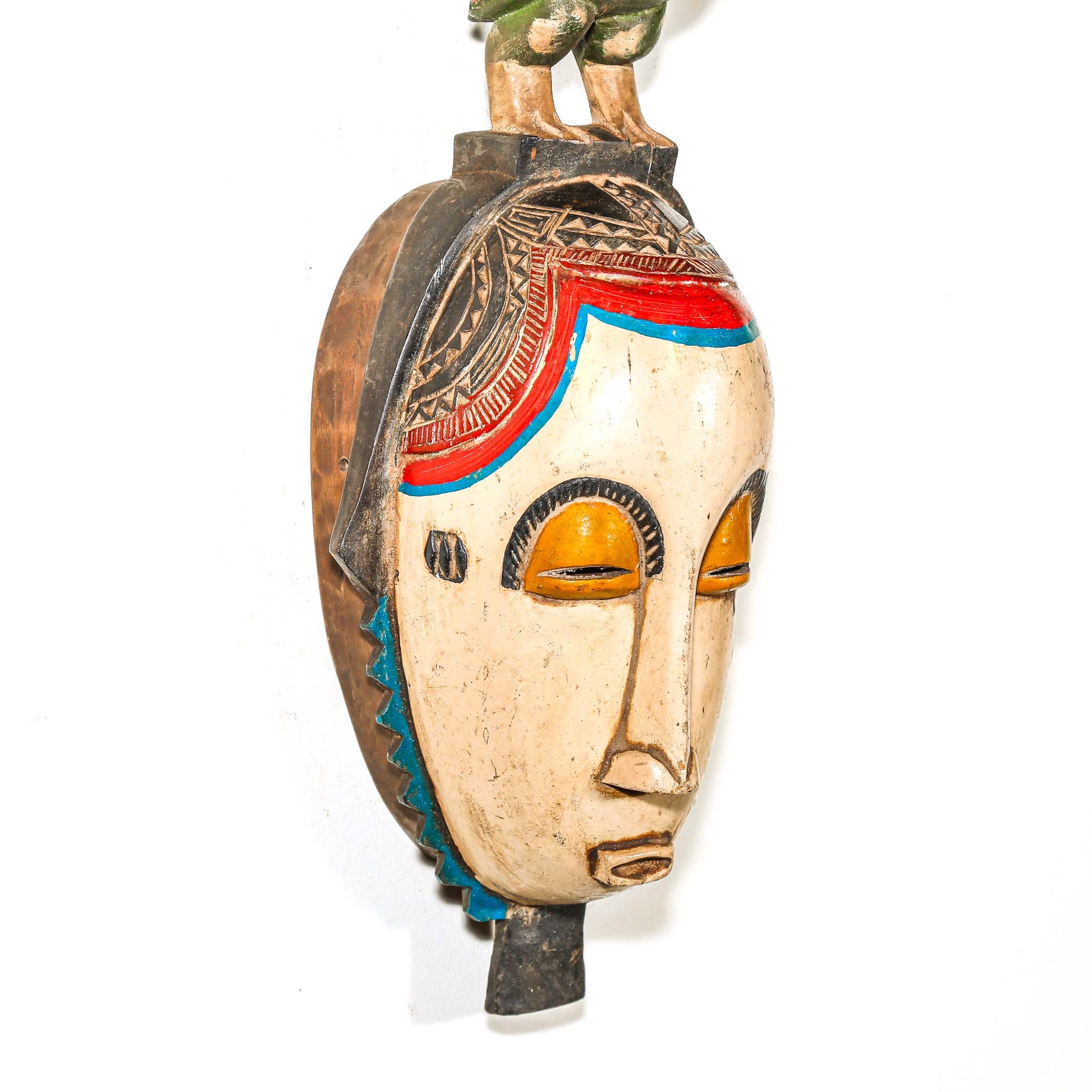 Decorative mask with colorful design on a white background