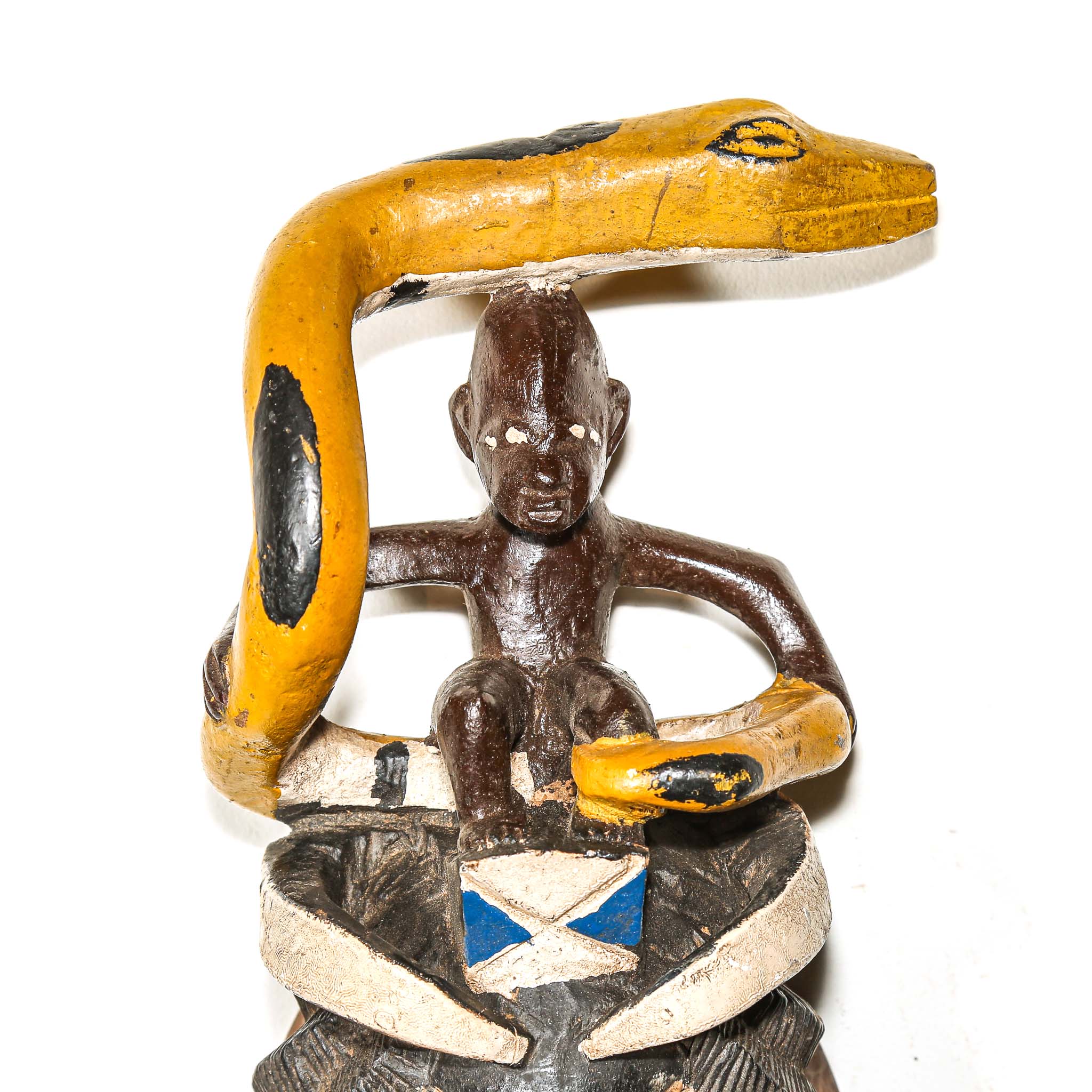 Decorative figurine with a snake and human figure on a white background