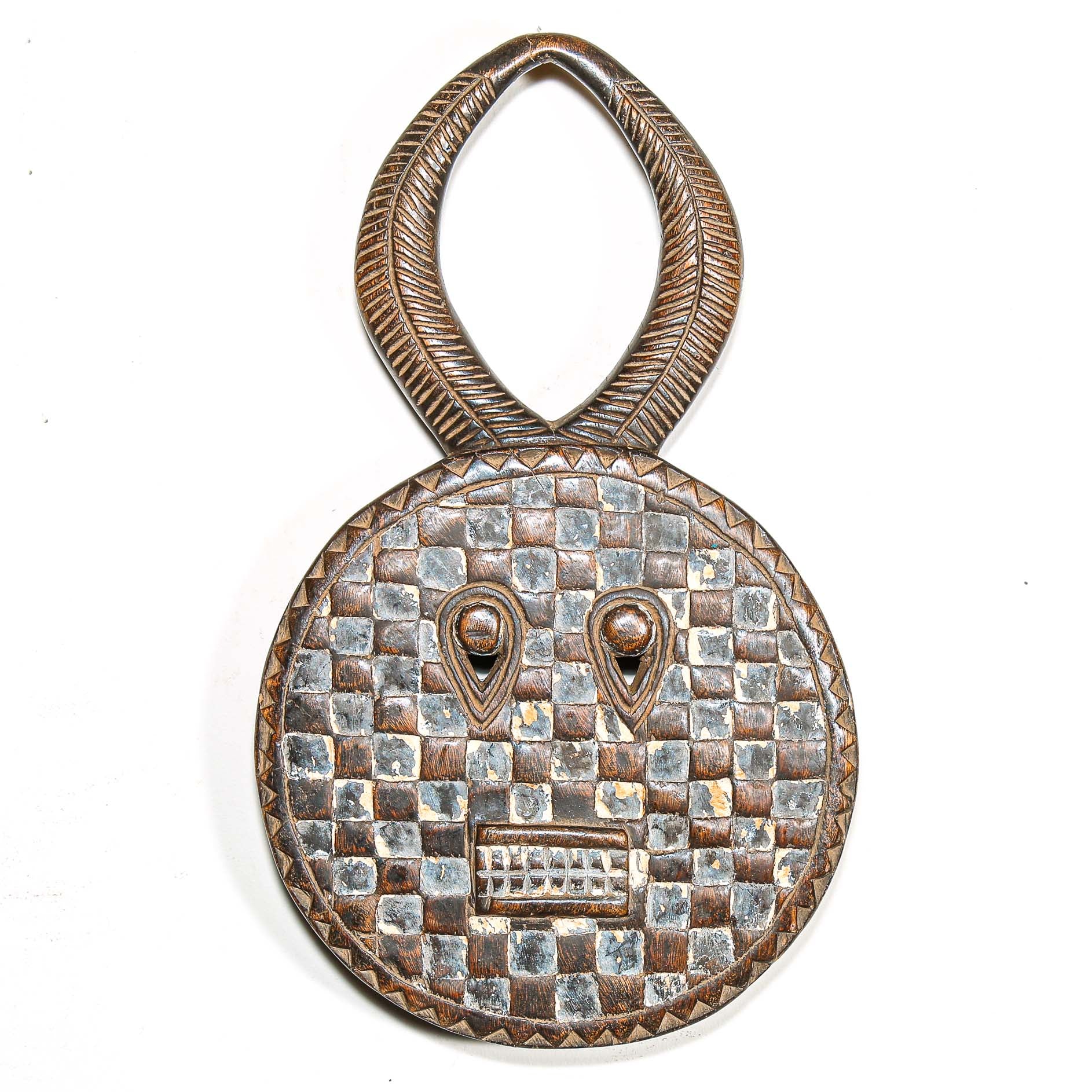 Decorative wooden traditional african mask with checkered pattern and eye design on a white background