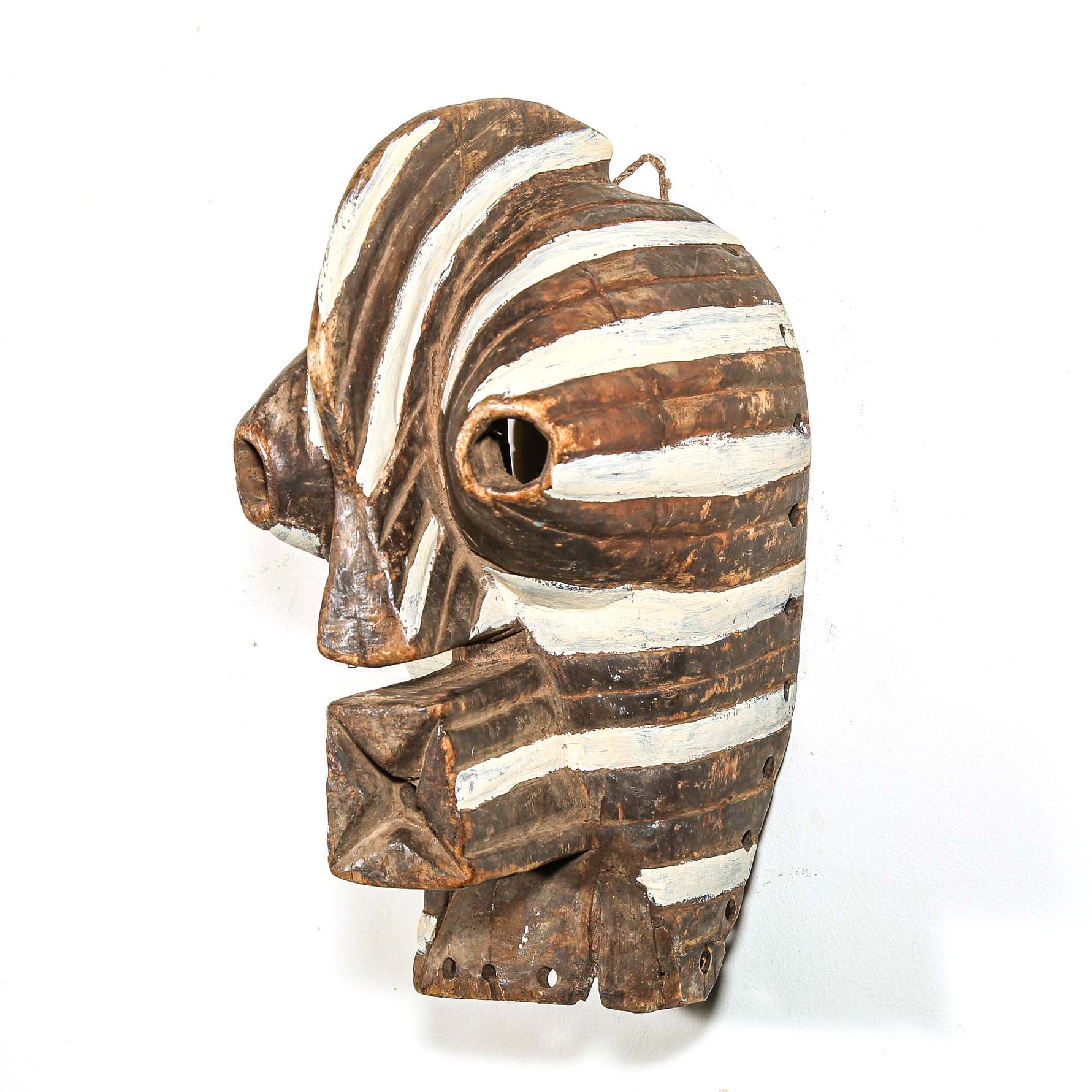 Wooden mask with striped design on a white background