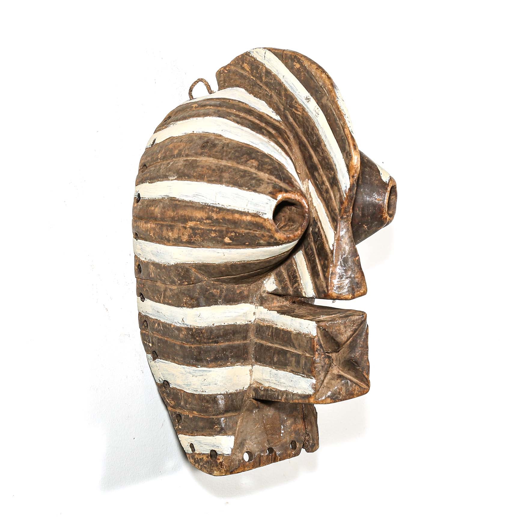 Wooden mask with striped design on a white background
