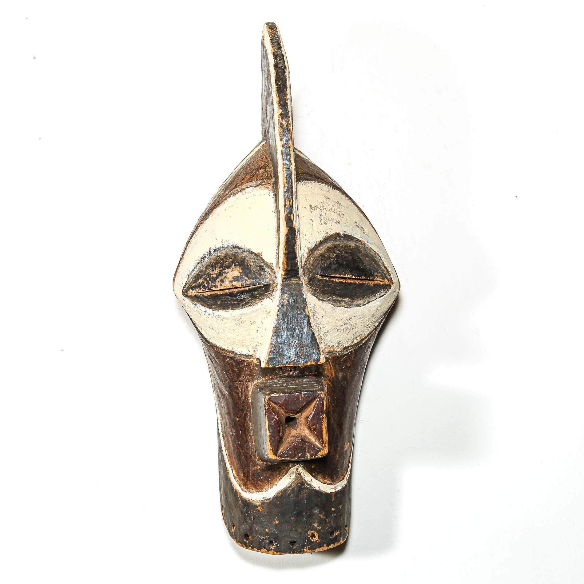 African mask with a white face and brown accents on a white background