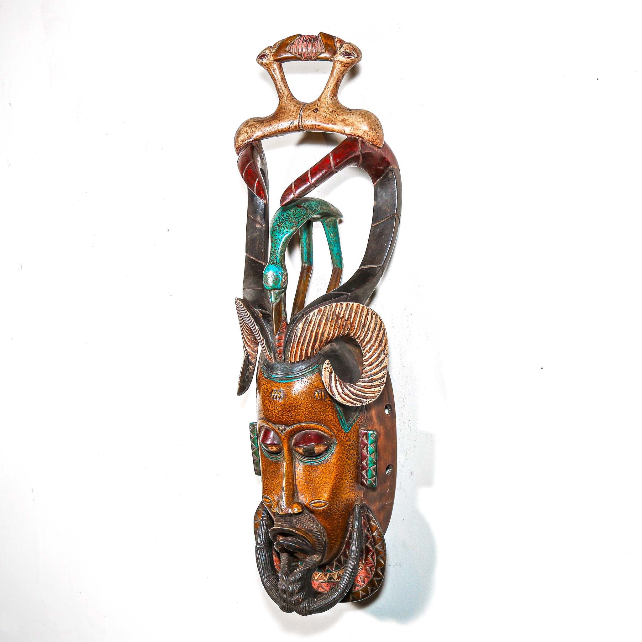 Authentic African mask to purchase online with colorful designs on a white background