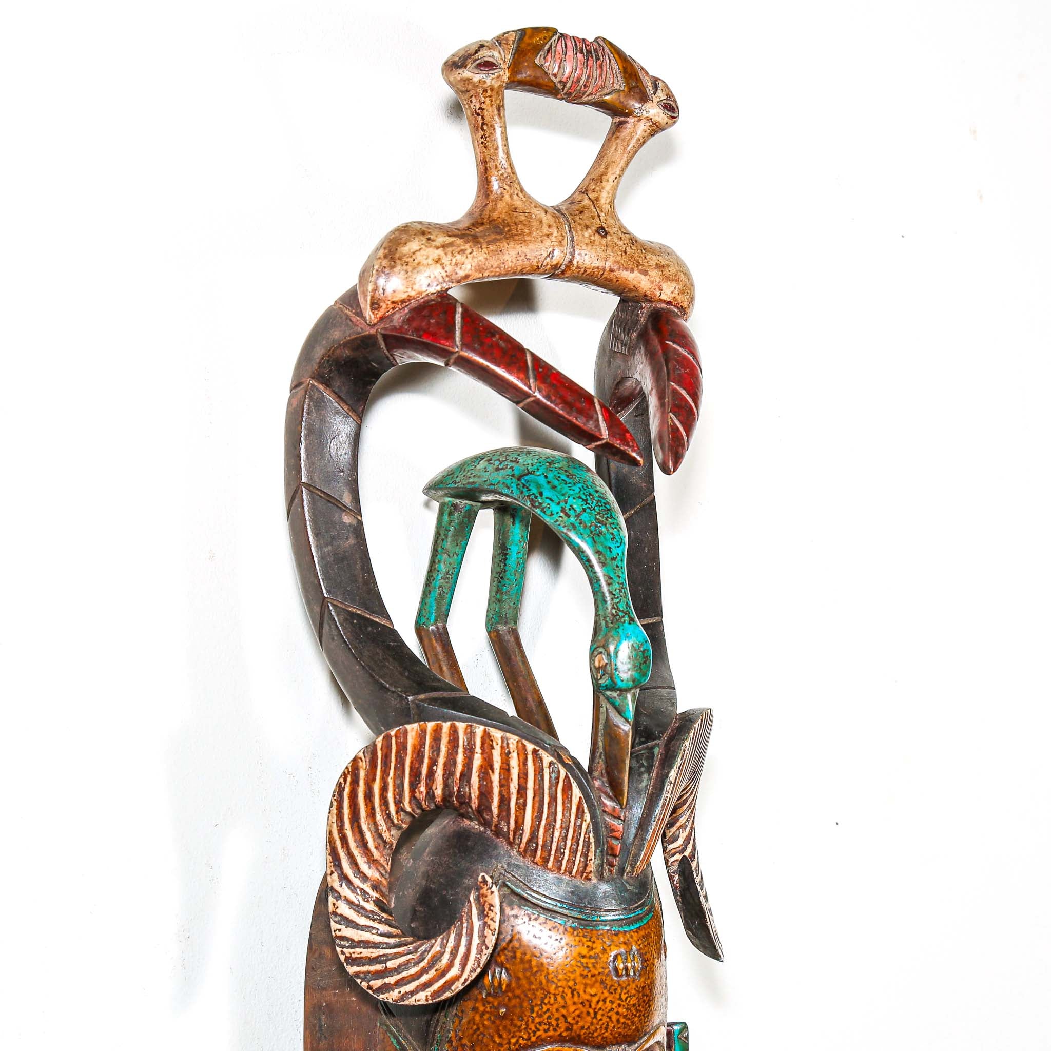 Authentic African mask to purchase online with colorful designs on a white background