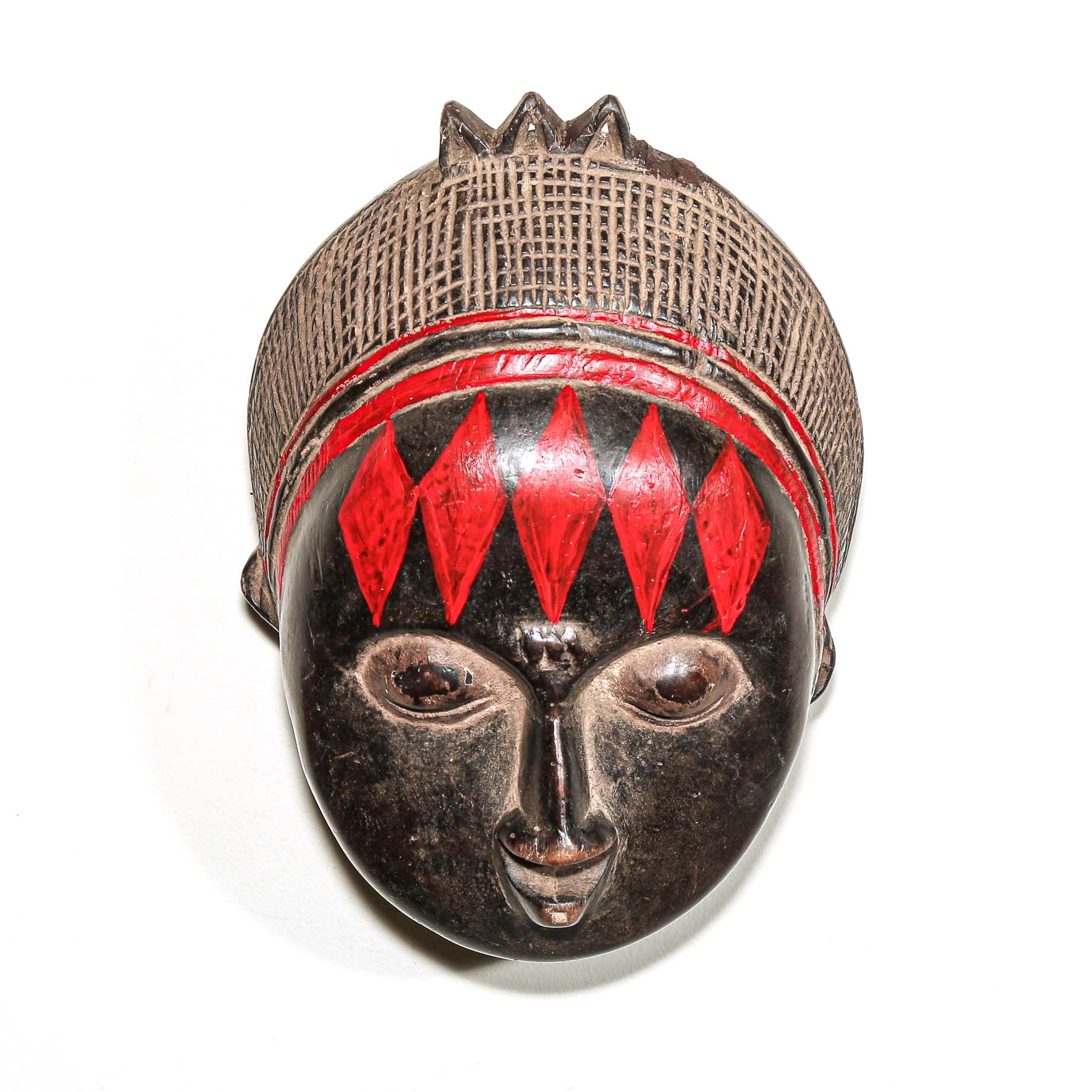 Decorative fine art african mask with red accents on a white background