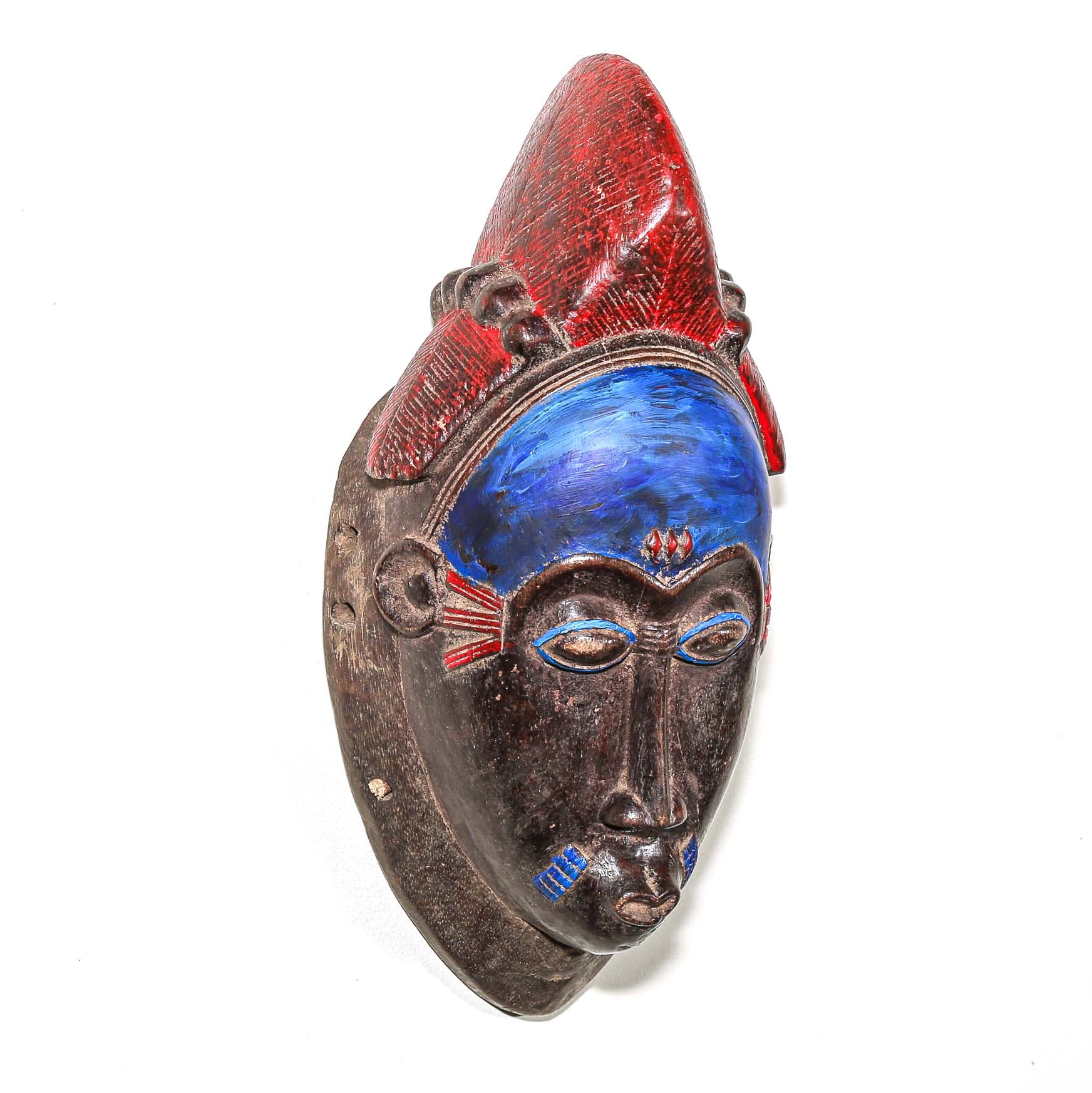 Decorative fine art african mask with red and blue accents on a white background
