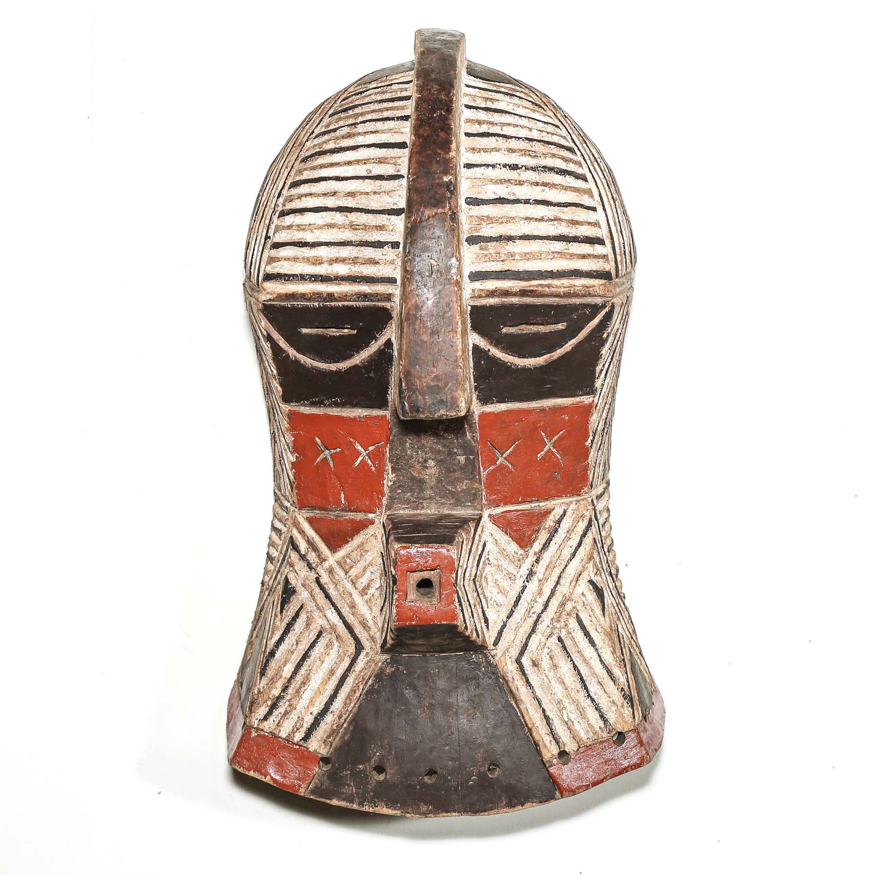 African art piece, specifically a wooden mask with geometric patterns on a white background. Tribal African art for sale.