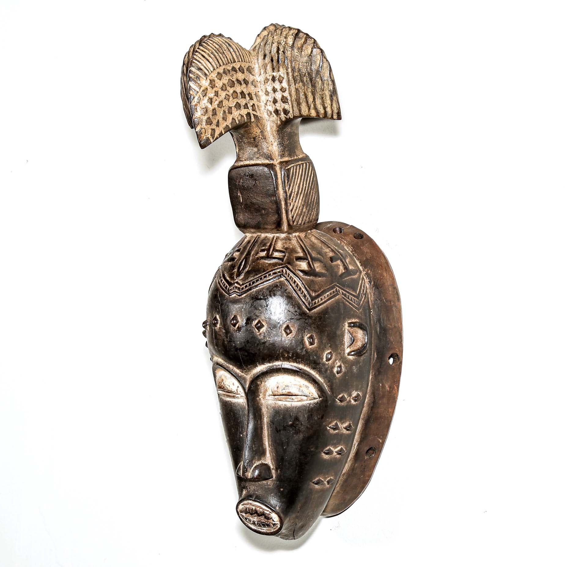 Fine African wood mask with intricate designs on a white background. Traditional tribal art for sale