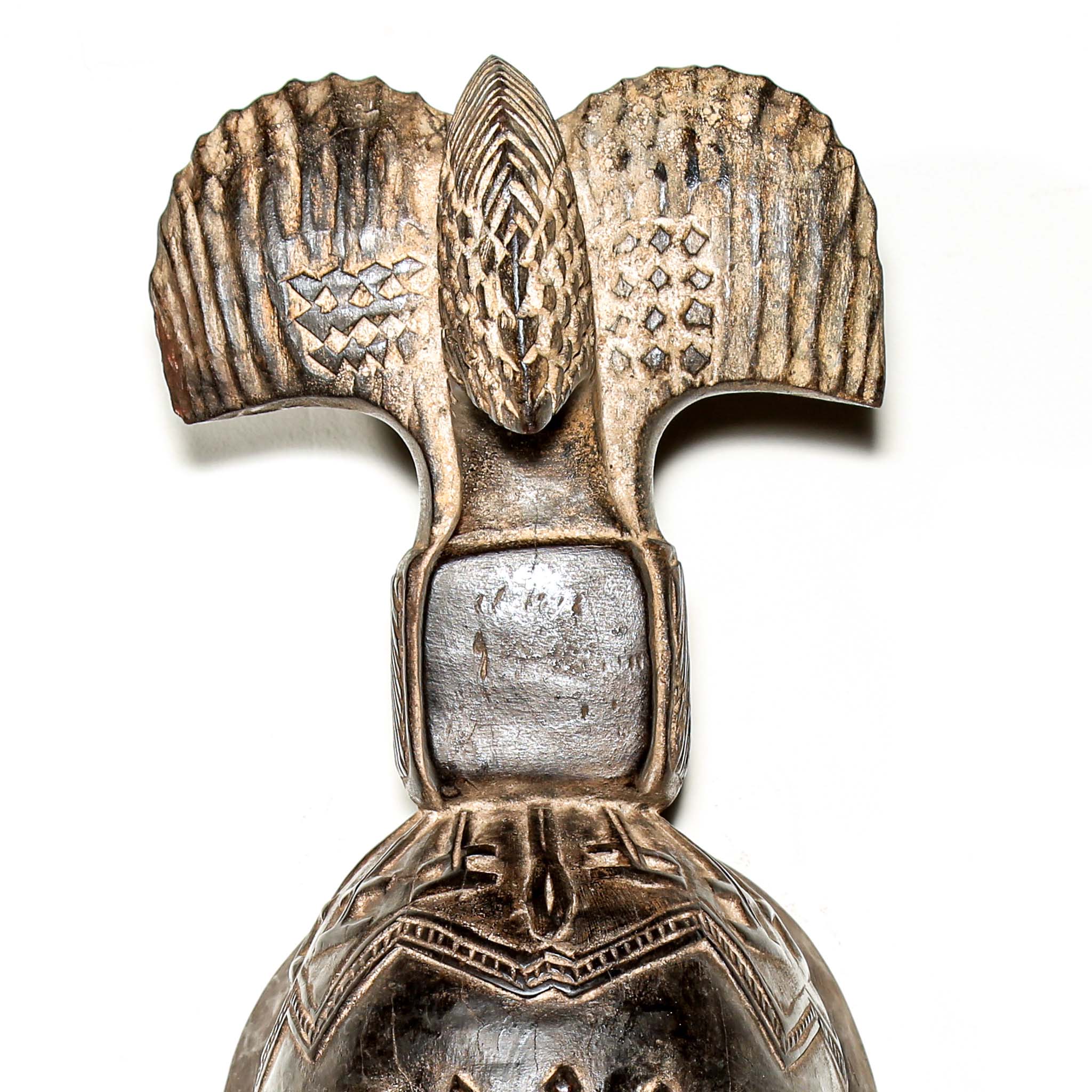 Fine African wood mask with intricate designs on a white background. Traditional tribal art for sale