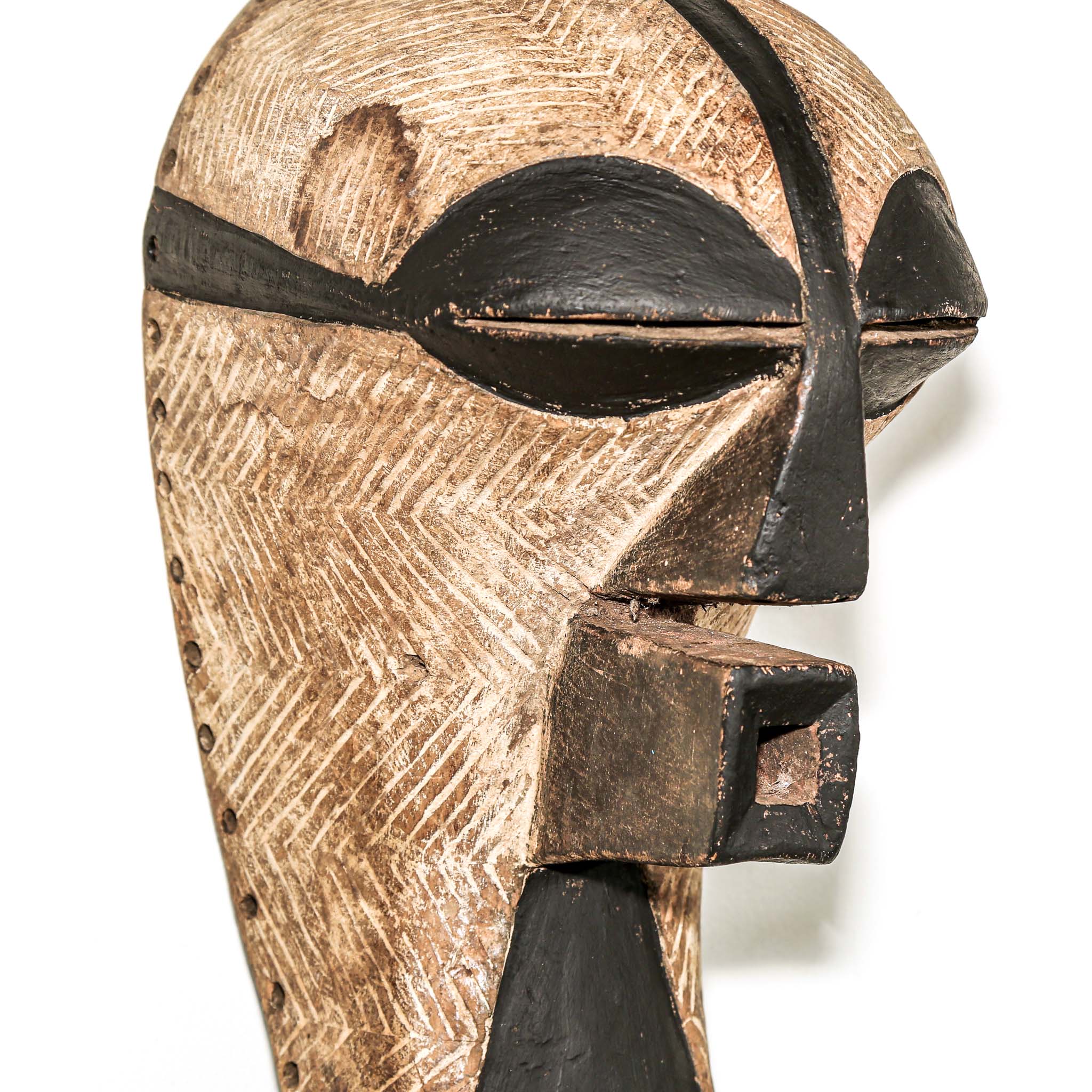 black and white Wooden african ceremonial mask with black accents on a white background