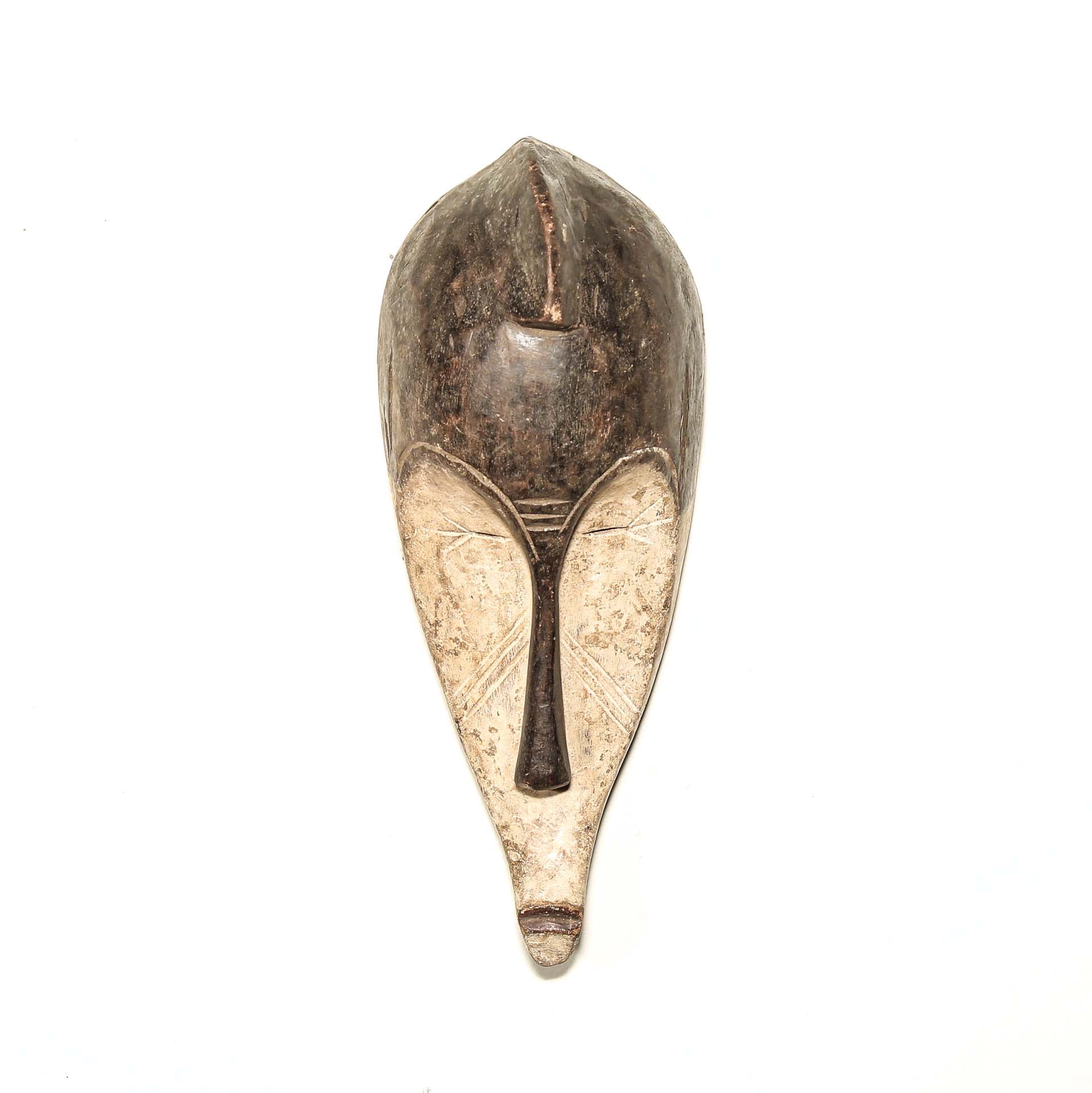 Wooden traditional African mask with black and white face on a white background. Fine Art from Africa for sale