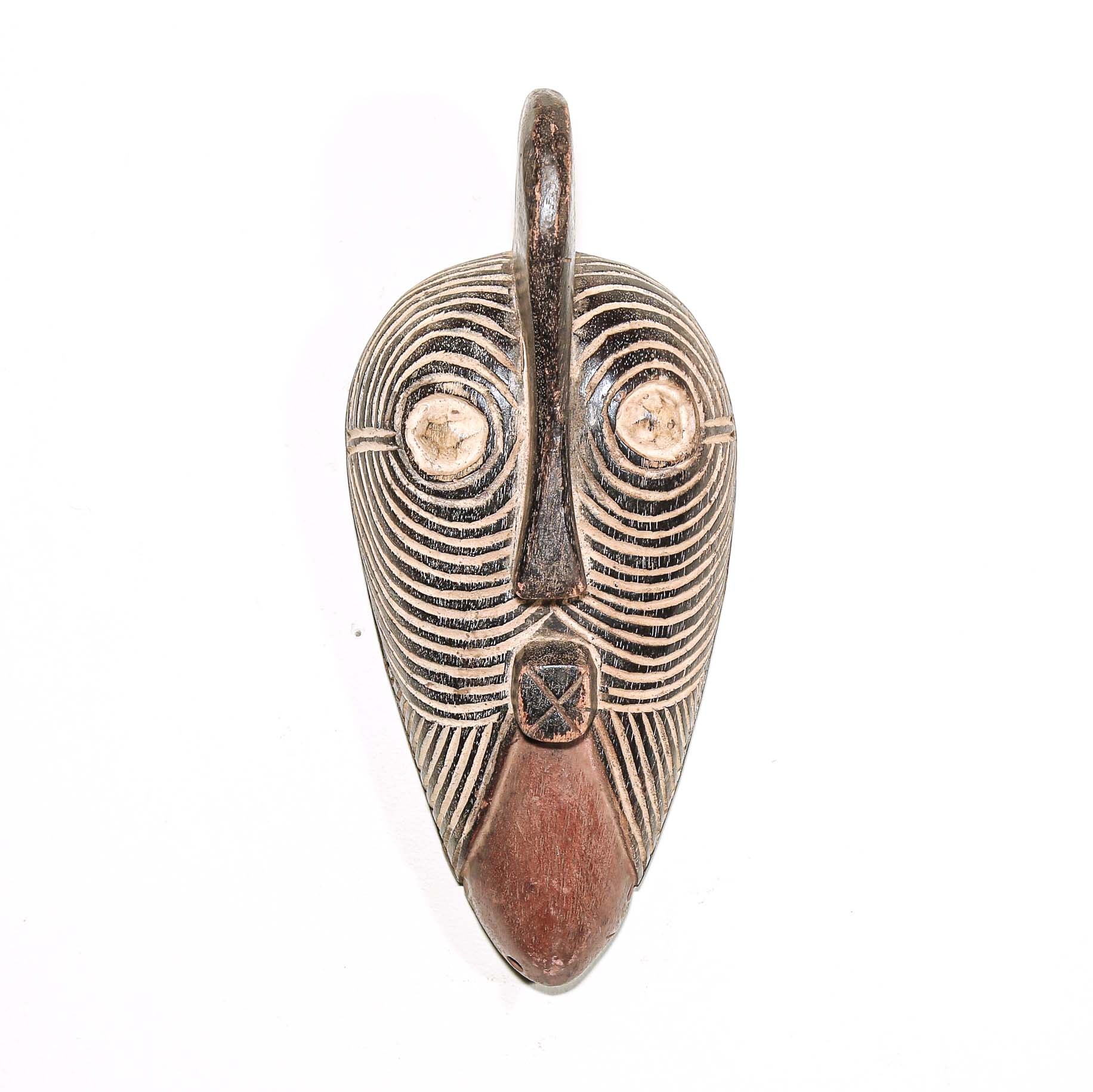 Wooden traditional African mask with black and white face on a white background. Fine Art from Africa for sale