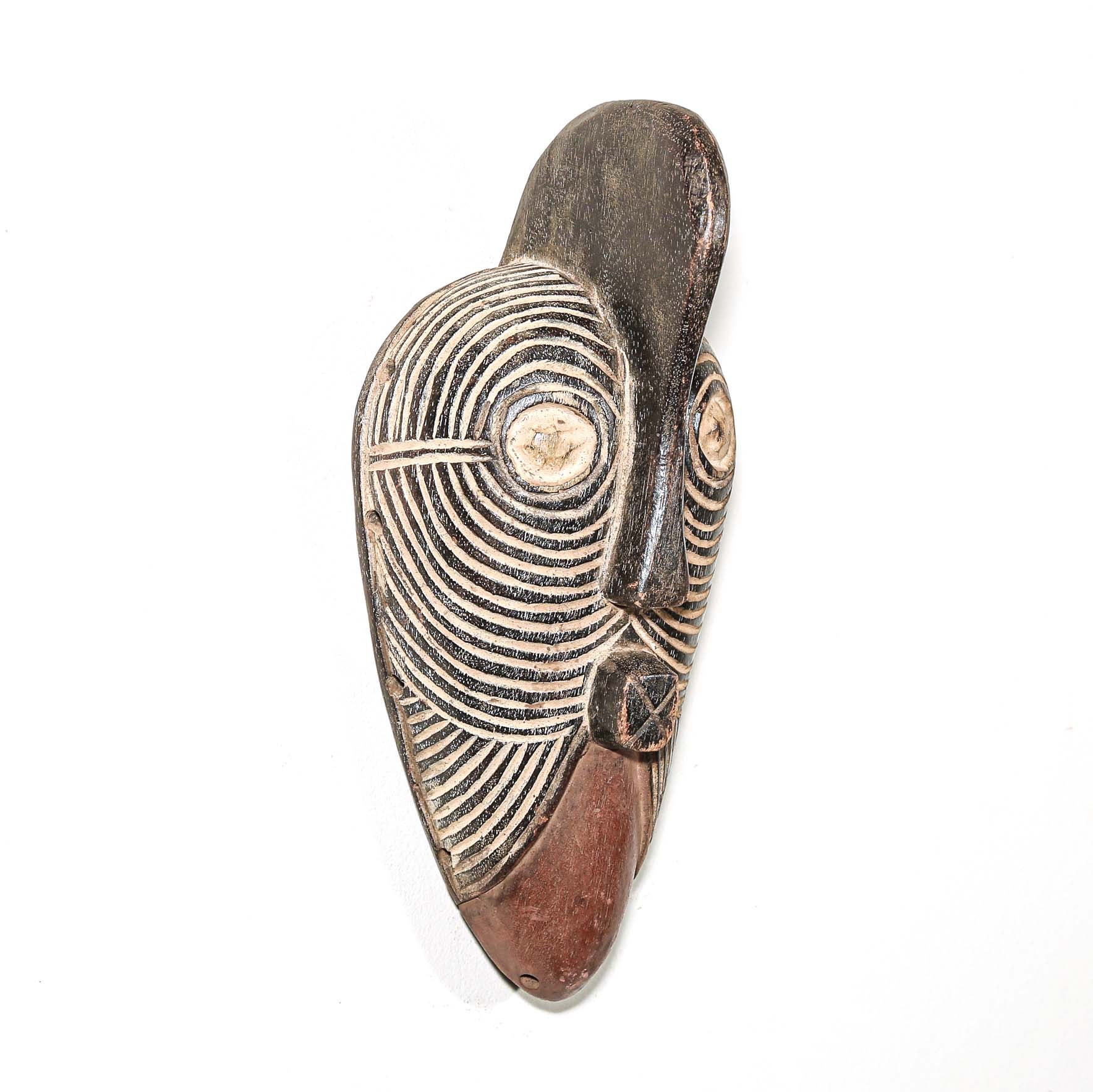 Wooden traditional African mask with black and white face on a white background. Fine Art from Africa for sale