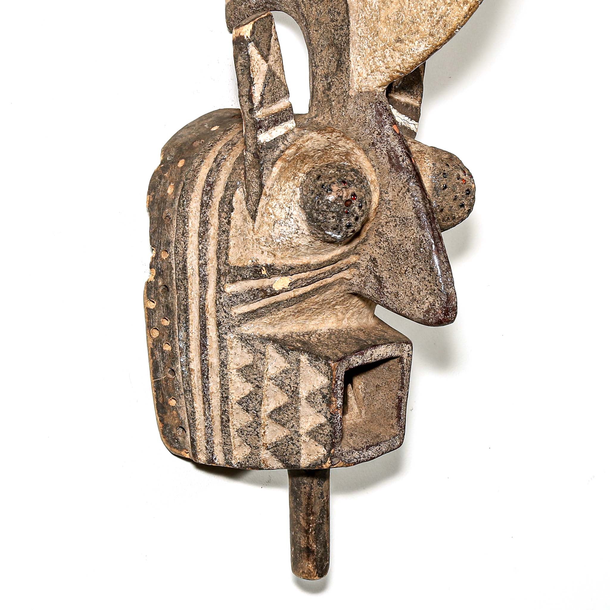 wood African mask black art colors hanging on a bedroom wall. African art for sale for collectors