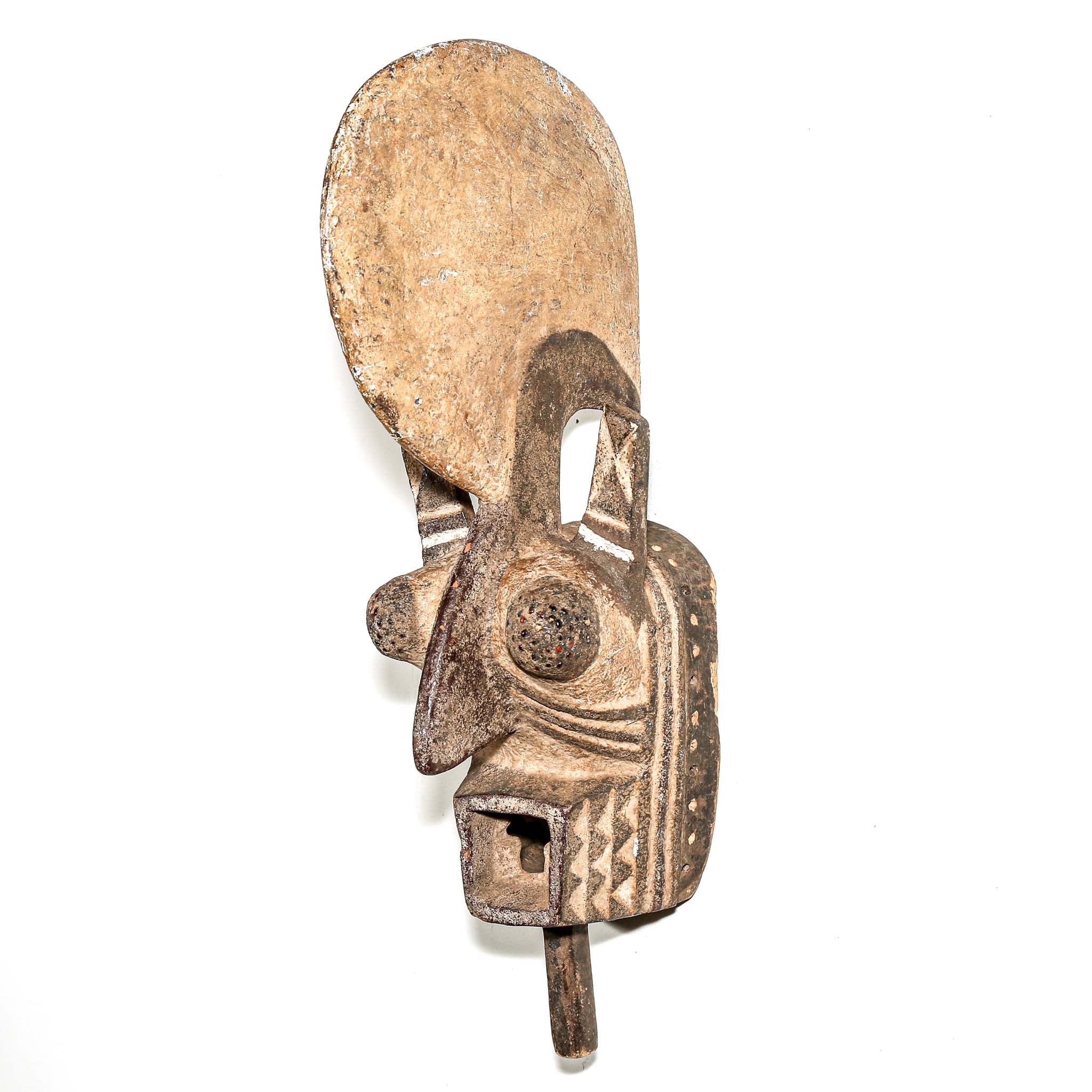 wood African mask black art colors hanging on a bedroom wall. African art for sale for collectors