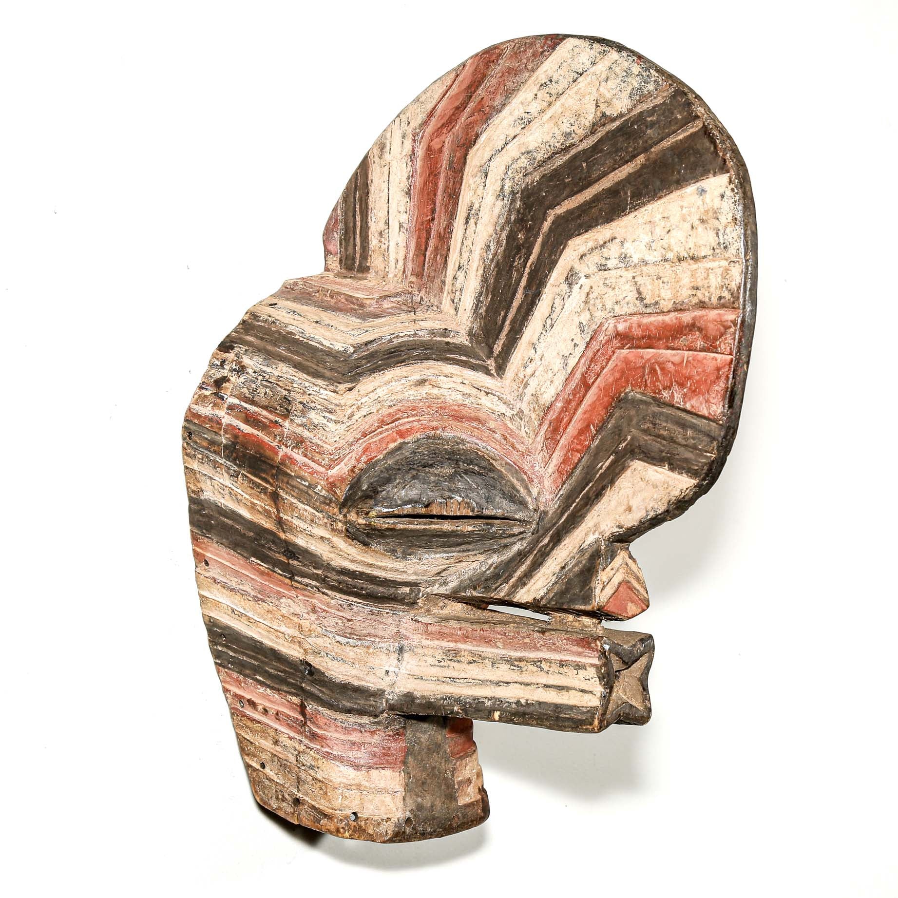 colorful Wooden African mask with striped pattern hanging on a white wall for sale