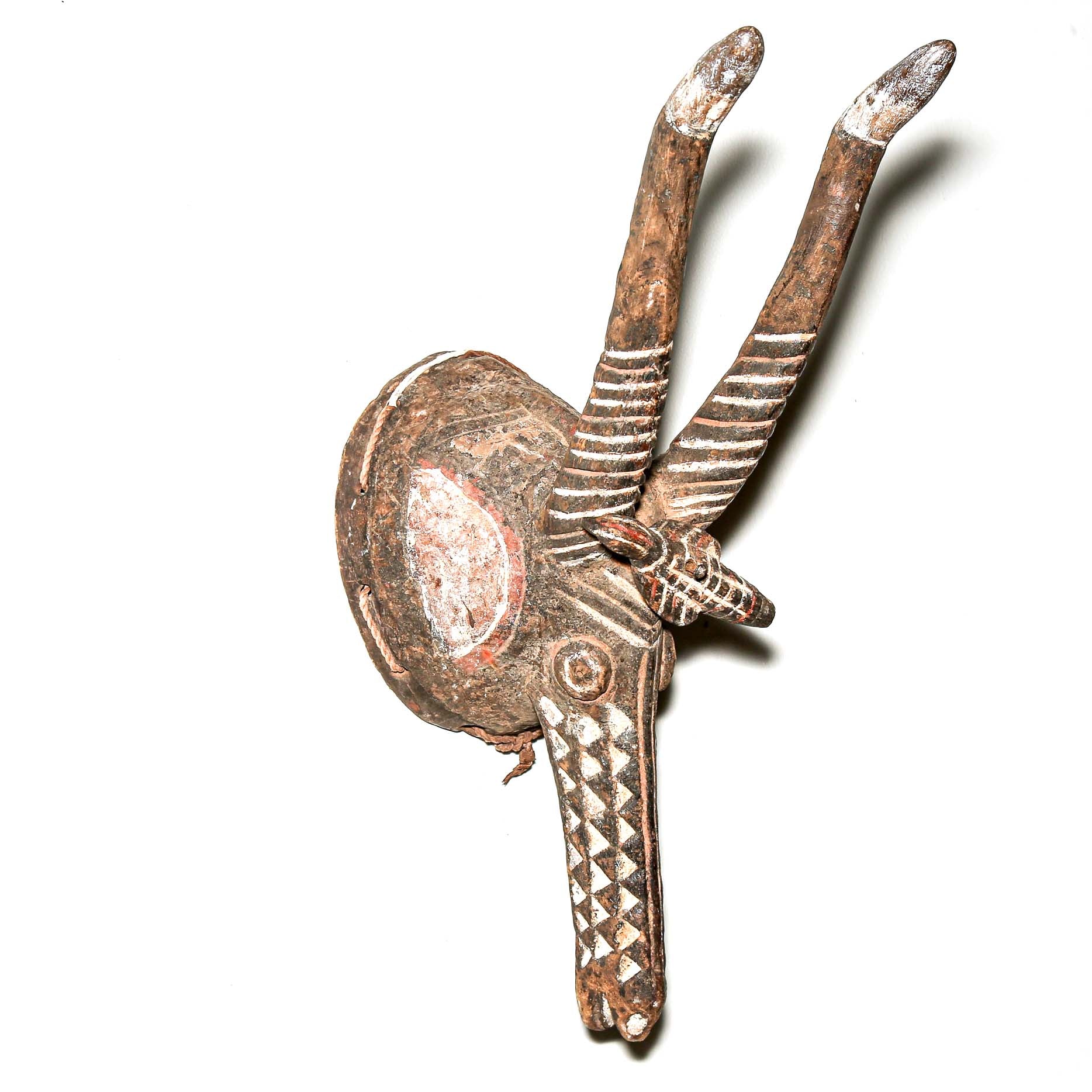 traditional tribal art mask with antlers on a white background