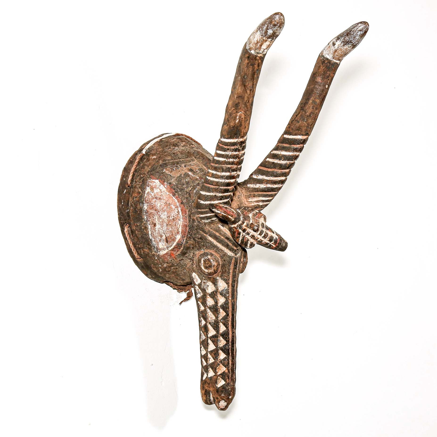 traditional tribal art mask with antlers on a white background for sale