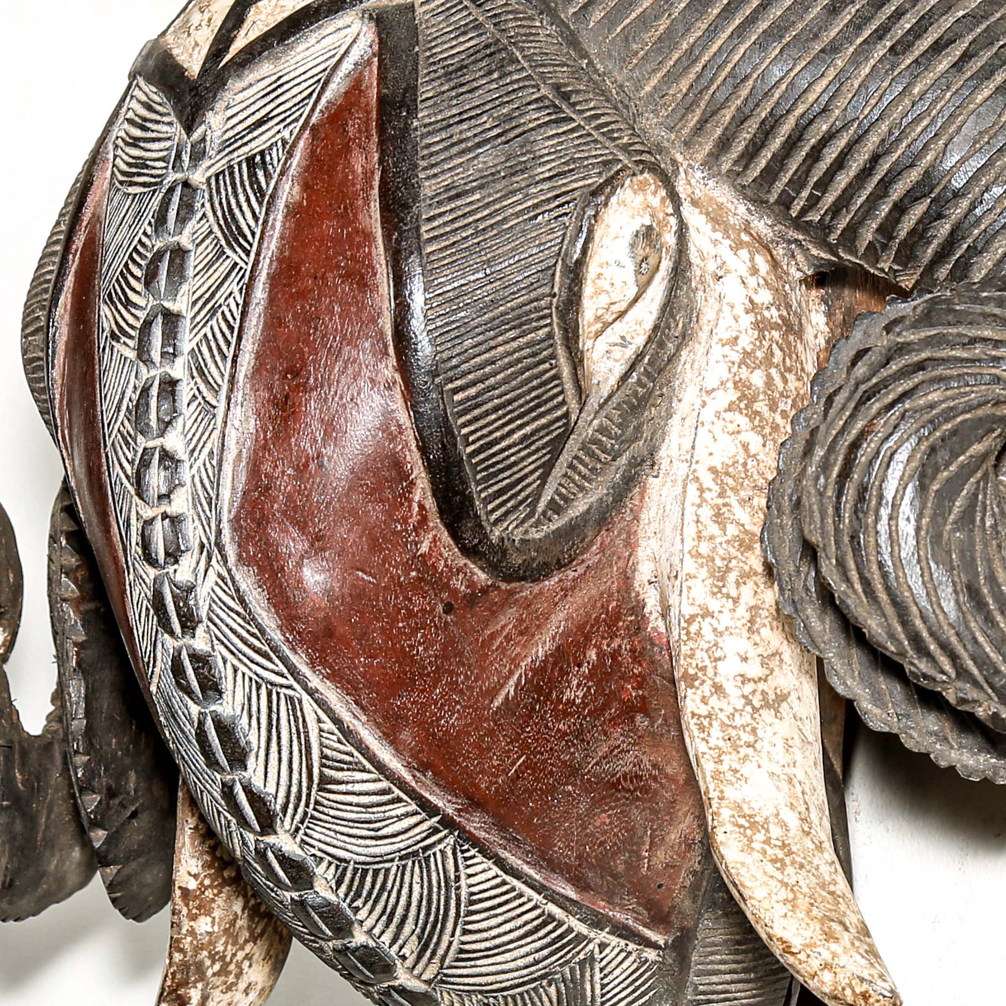 high end African ram's head sculpture with intricate patterns on a white background