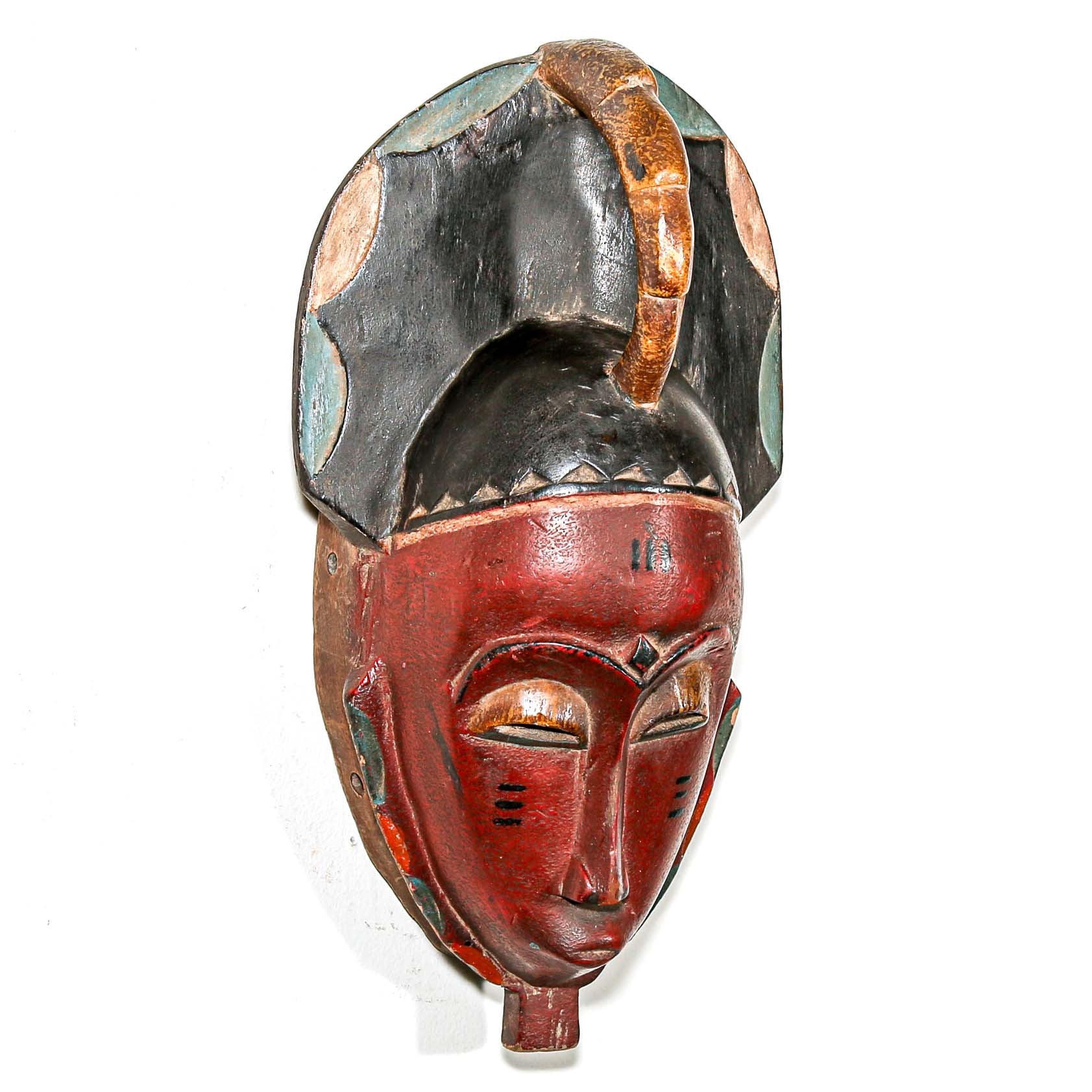 Red collectable African tribal mask for modern interior design ideas