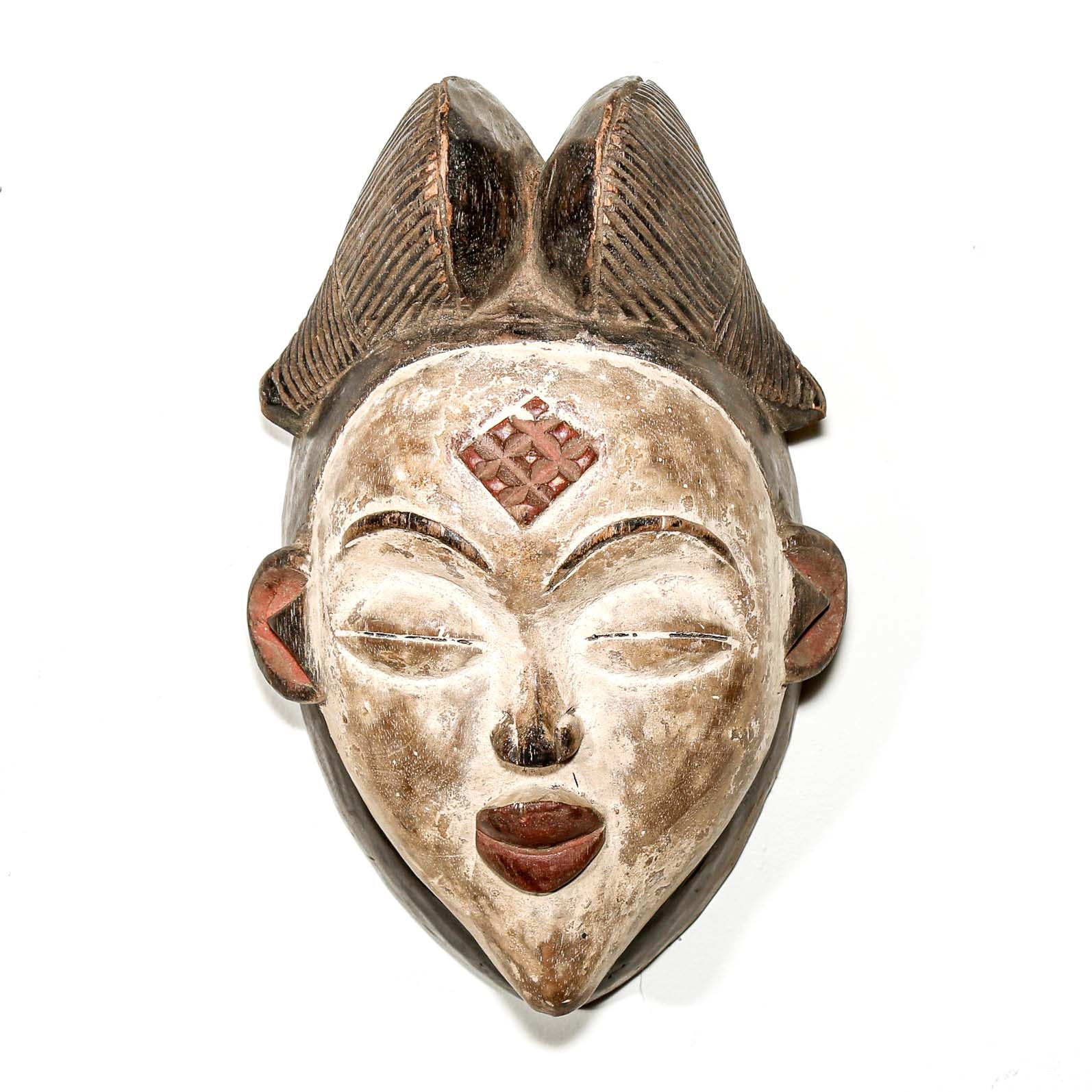 African mask with intricate designs on a white background