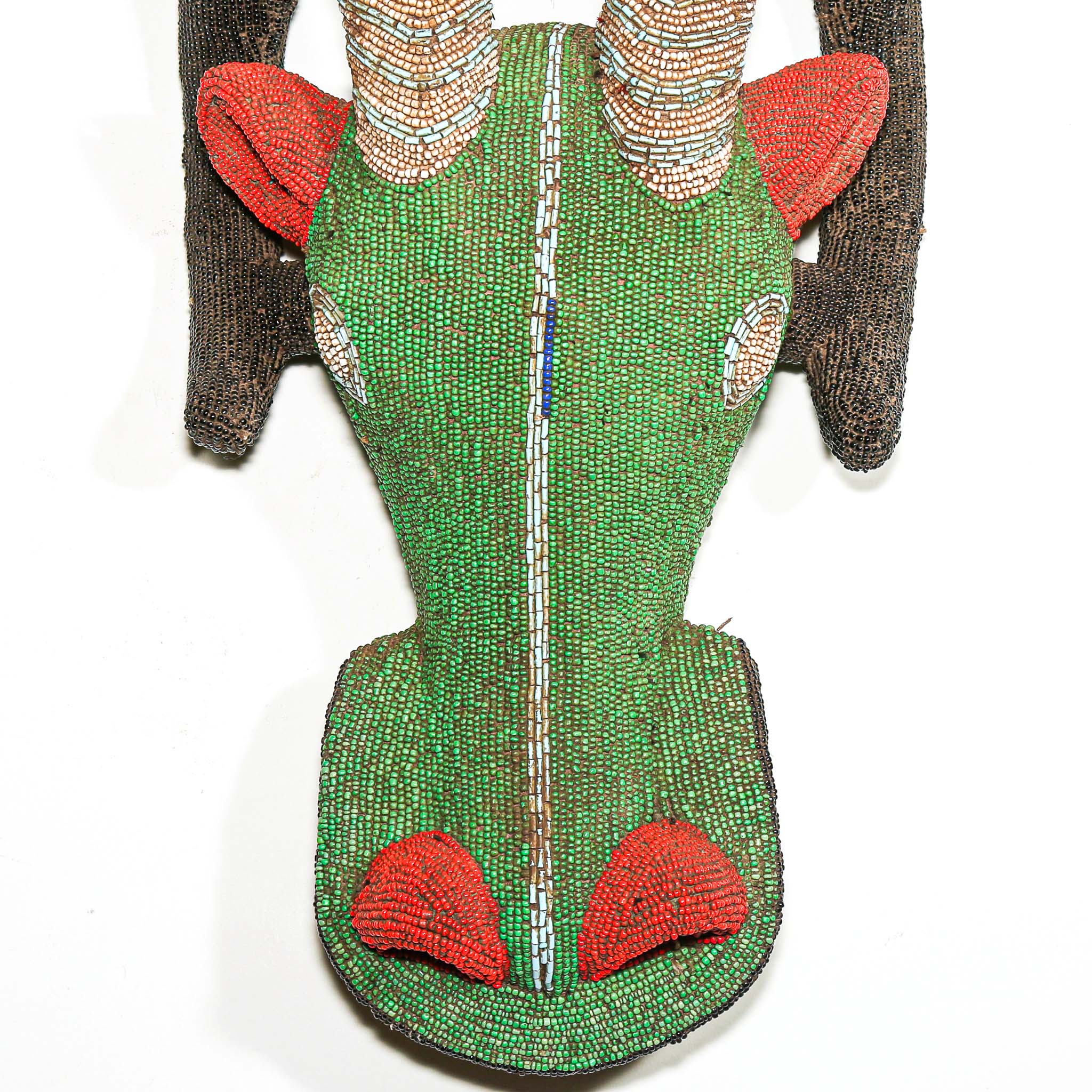 Decorative wall hanging with green and red pattern on a white background