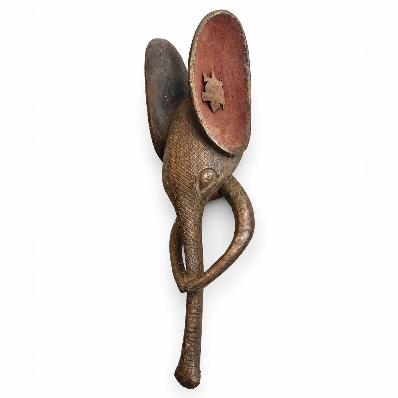 Decorative wall mask of a elephant from Africa made from wood and metal with a unique design on a white background