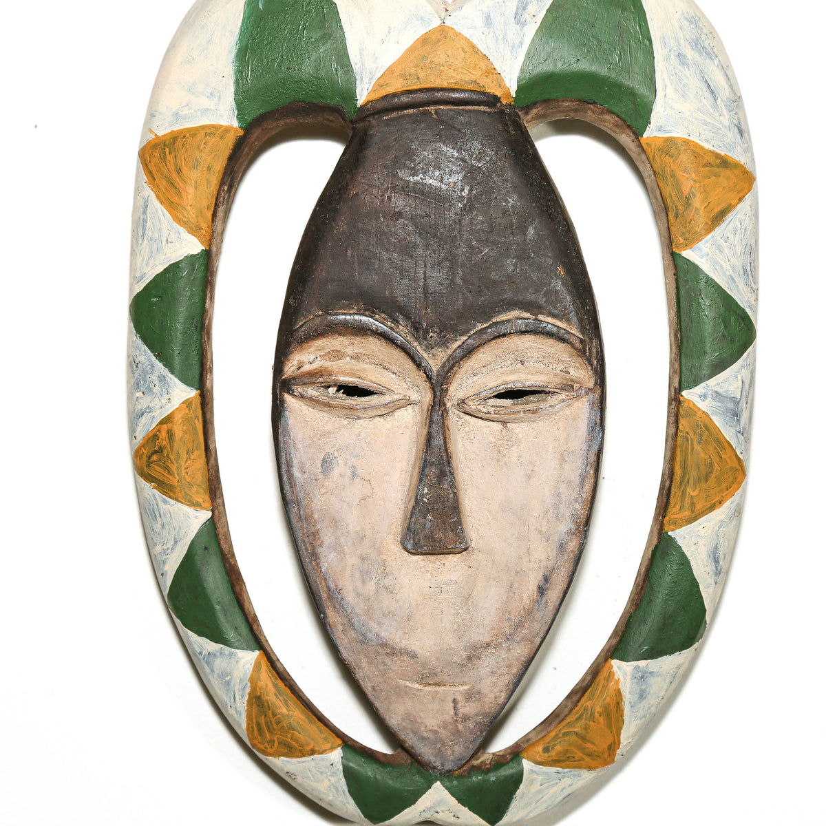 Painted Kwele mask with green, yellow, and white geometric patterns and elegant carved facial features