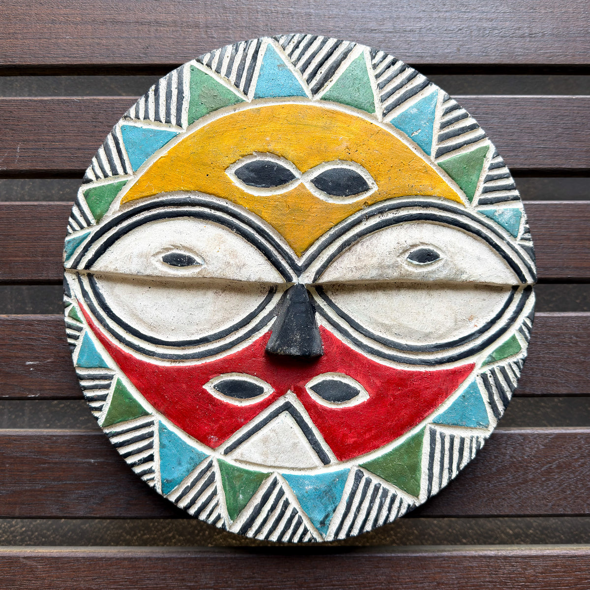Brightly colored Teke mask from Congo with bold geometric patterns and vivid painted details for African wall decor