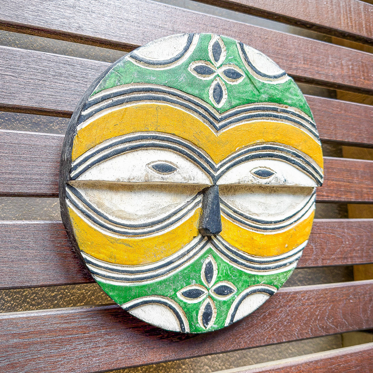 Round Teke Kidumu mask from the Democratic Republic of Congo with bold geometric patterns and a distinctive circular form