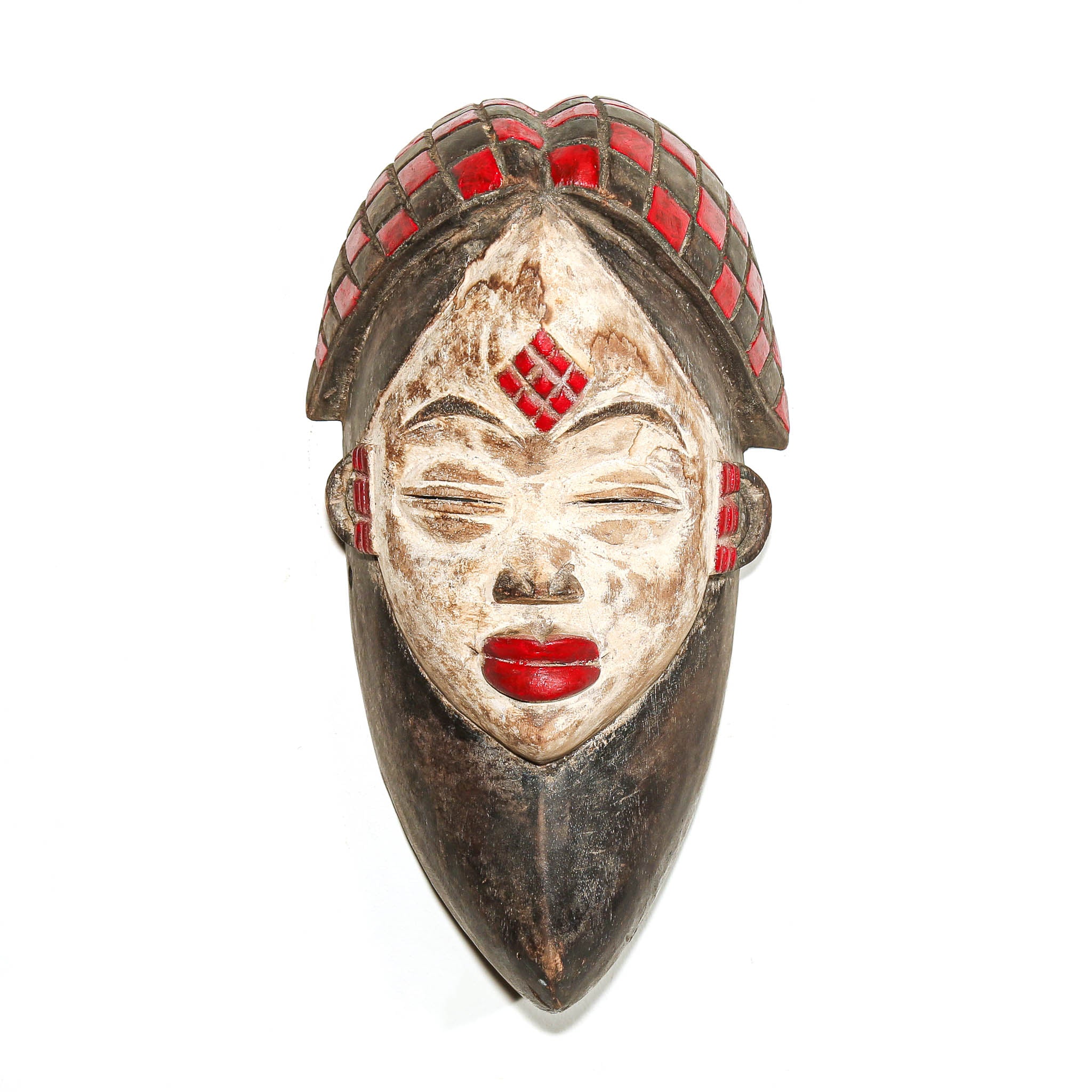 A carved African-style wooden mask with a serene female face, featuring red and black checkered details on the hair and cheeks, and bright red painted lips, set against a plain white background.