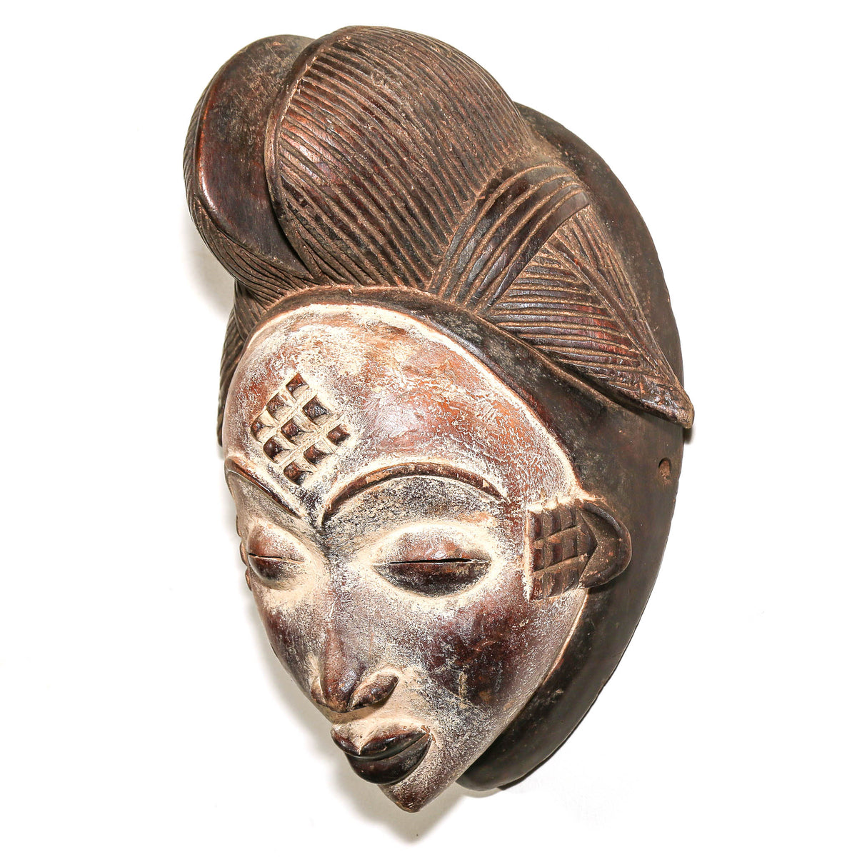 Hand-carved large Punu face mask with graceful expression and sculptural wood form, displayed as collectible African tribal art