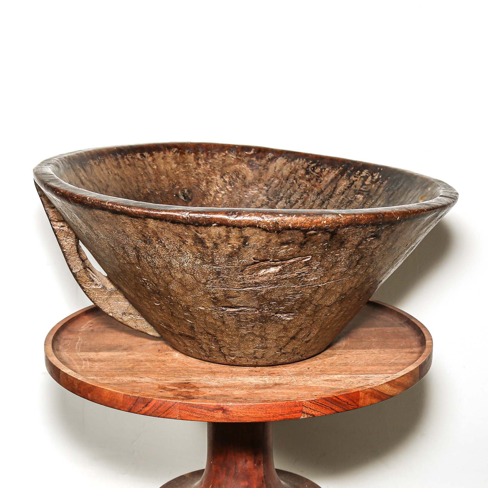Wooden bowl on a wooden stand with a white background