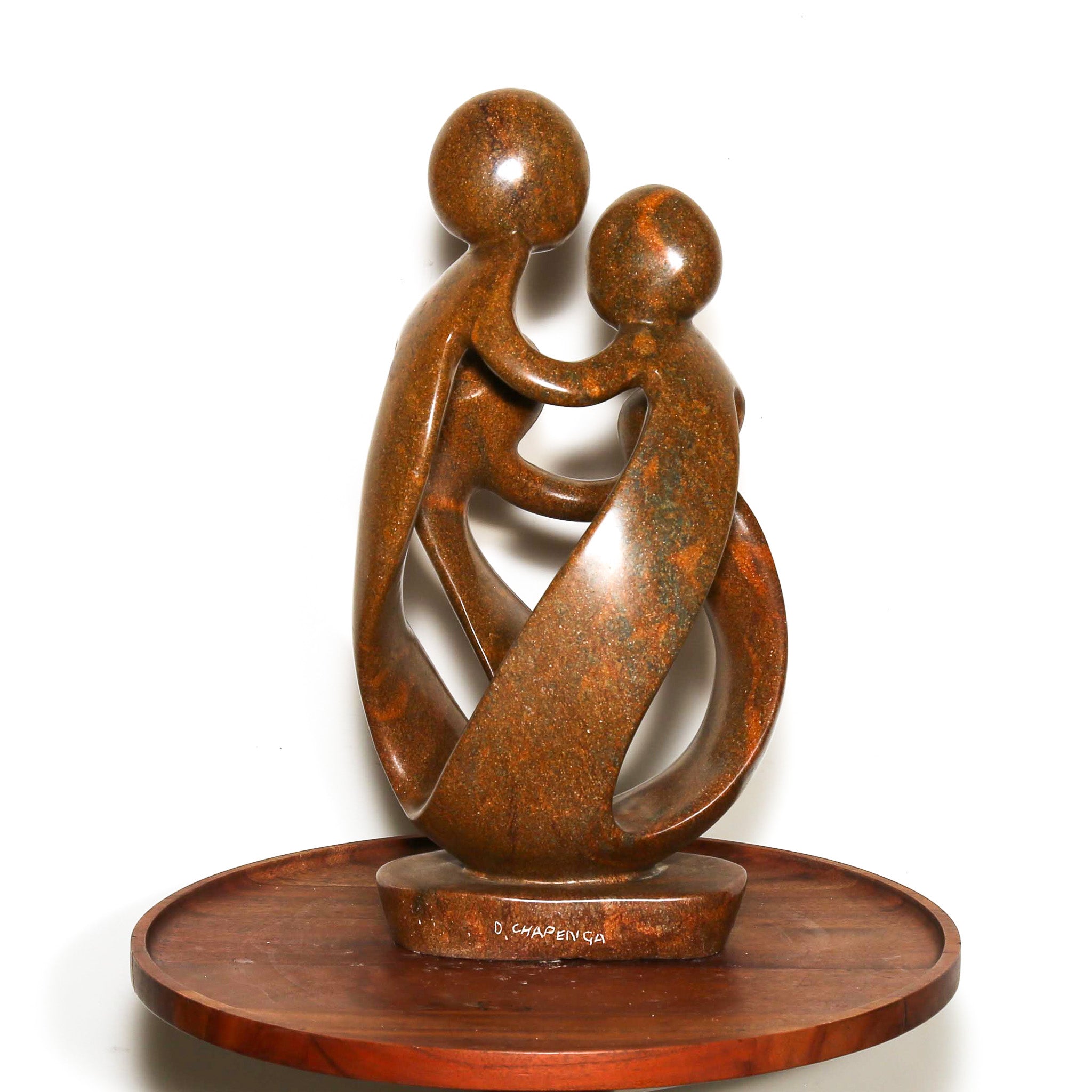 signed stone statue of a mother, father, and two children