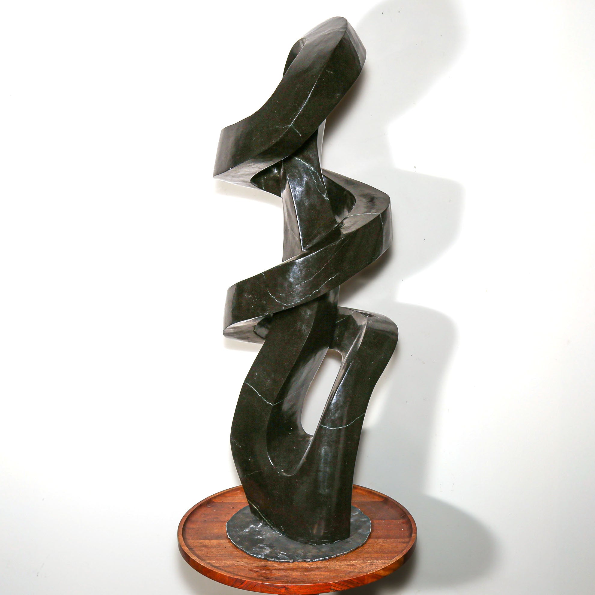 "Continuum" Abstract Sculpture by D. Musekiwa on a wood side table