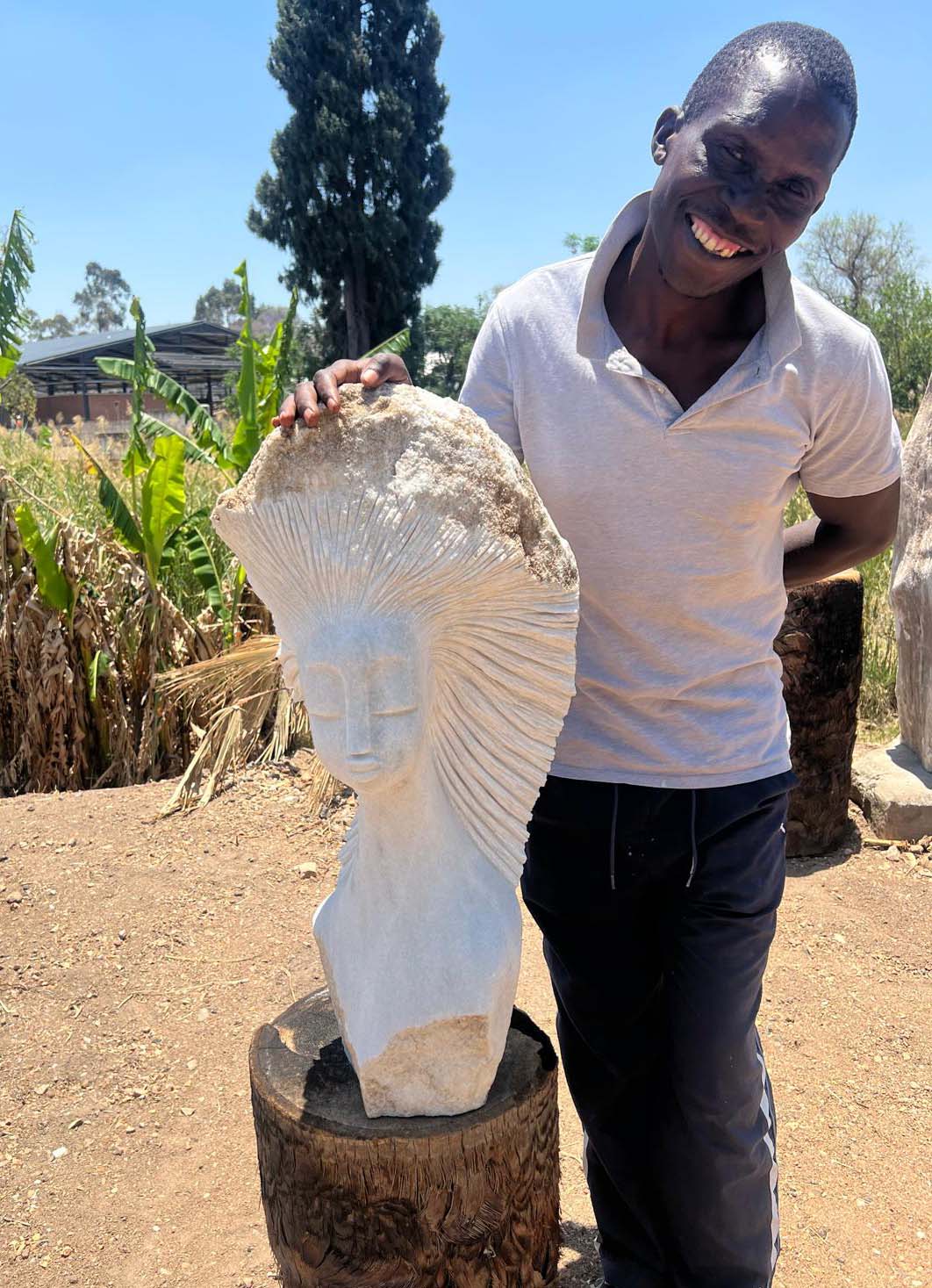 African artist in Zimbabwe with his sculpture