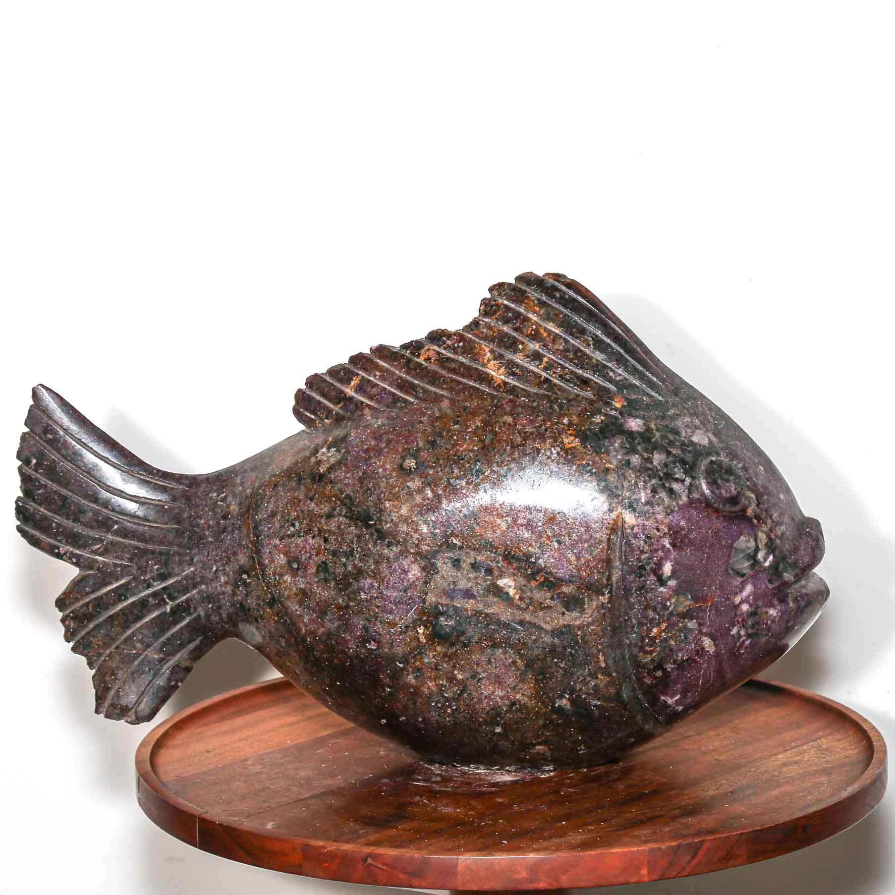 Purple stone sculpture of a fish