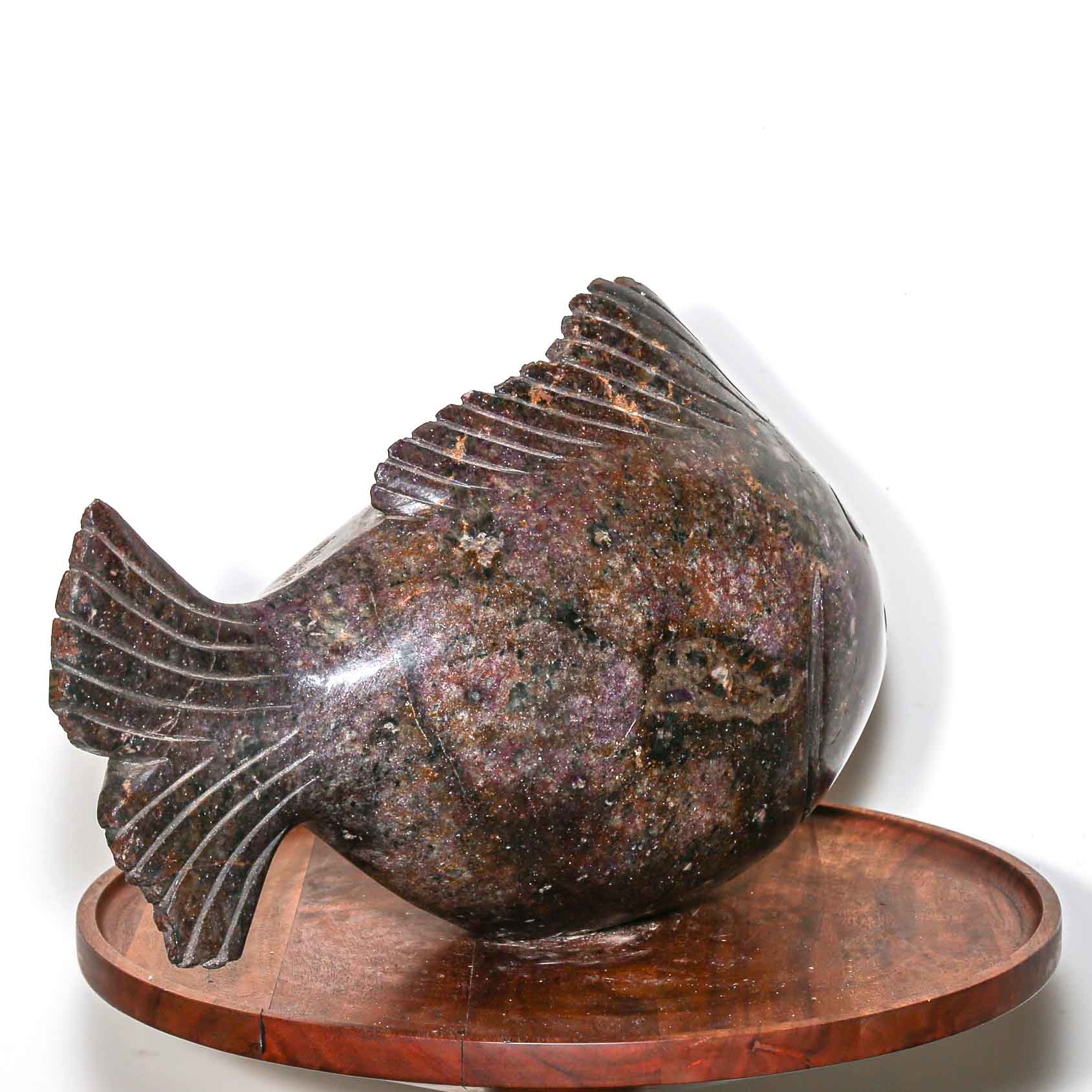Purple stone sculpture of a fish