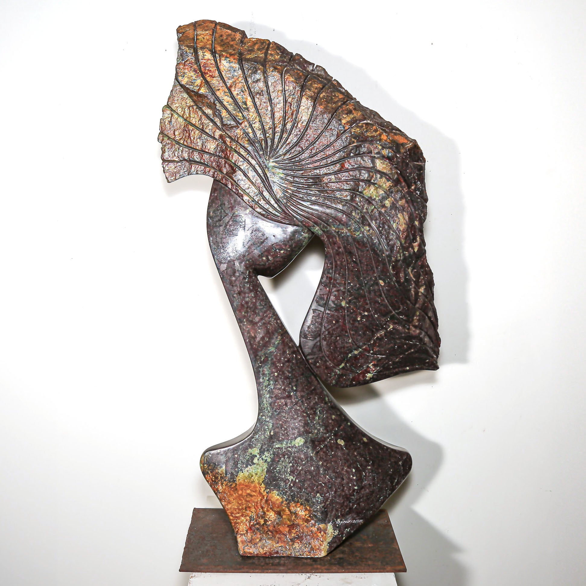 Purple Stone Sculpture of a Woman Titled "Windswept" by Lovemore Bonjisi with signature of the artist