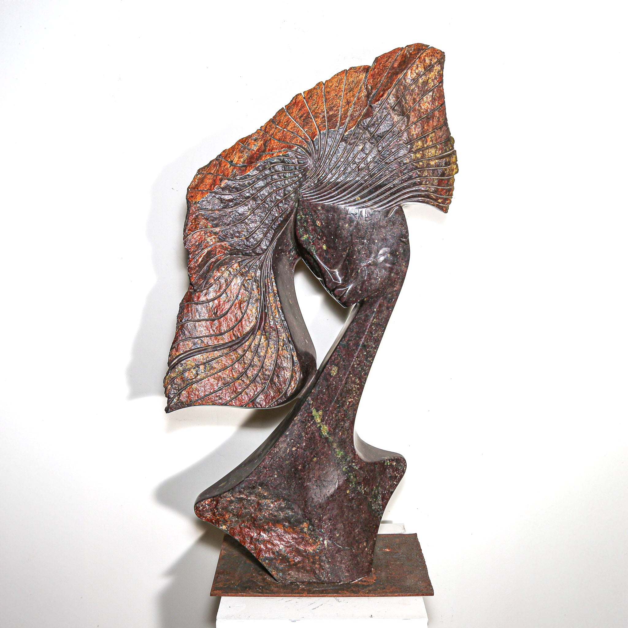 Purple Stone Sculpture of a Woman Titled "Windswept" by Lovemore Bonjisi with the subject's hair blowing in the wind