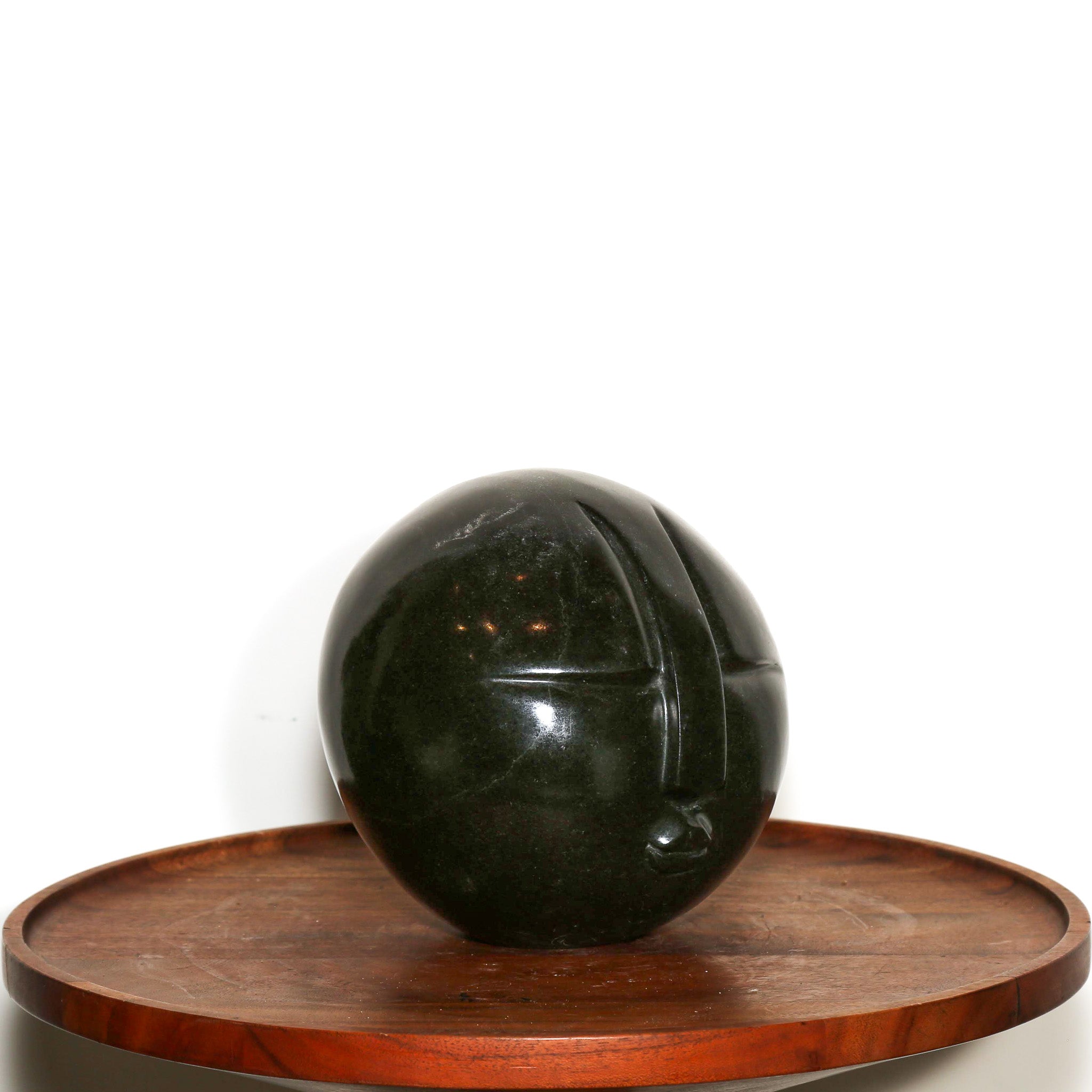 "Man in the Moon" Abstract Sculpture. Polish sphere of black stone with a carved abstract face